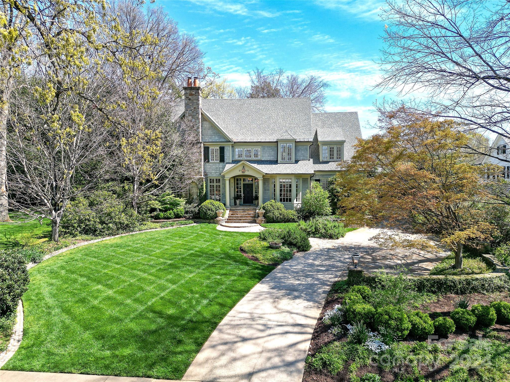 This grand Eastover home offers a lovely balance of comfort and elegance on a beautiful 1/2 acre lot.  You'll find high end finishes and premium materials throughout the inviting floor plan with spacious rooms, soaring ceilings and beautiful wide, heart of pine floors (rumored to be from a Hershey's plant). Five large bedrooms with primary suite on main, and 2 offices, one up, one down. In the heart of the 2nd floor is a space the seller's three girls used for homework - with a large table in the middle and shelving on both sides, it could be an art/craft room, study space or another office. Expansive bonus room and exercise room on 3rd floor along with copious amounts of walk in storage. Room above the garage is floored with windows and electricity, no HVAC but offers even more storage.  A screened porch off the family room overlooks the beautifully landscaped, fenced in back yard. Lovely rose garden by the friend's side entrance. This home is an Eastover gem.