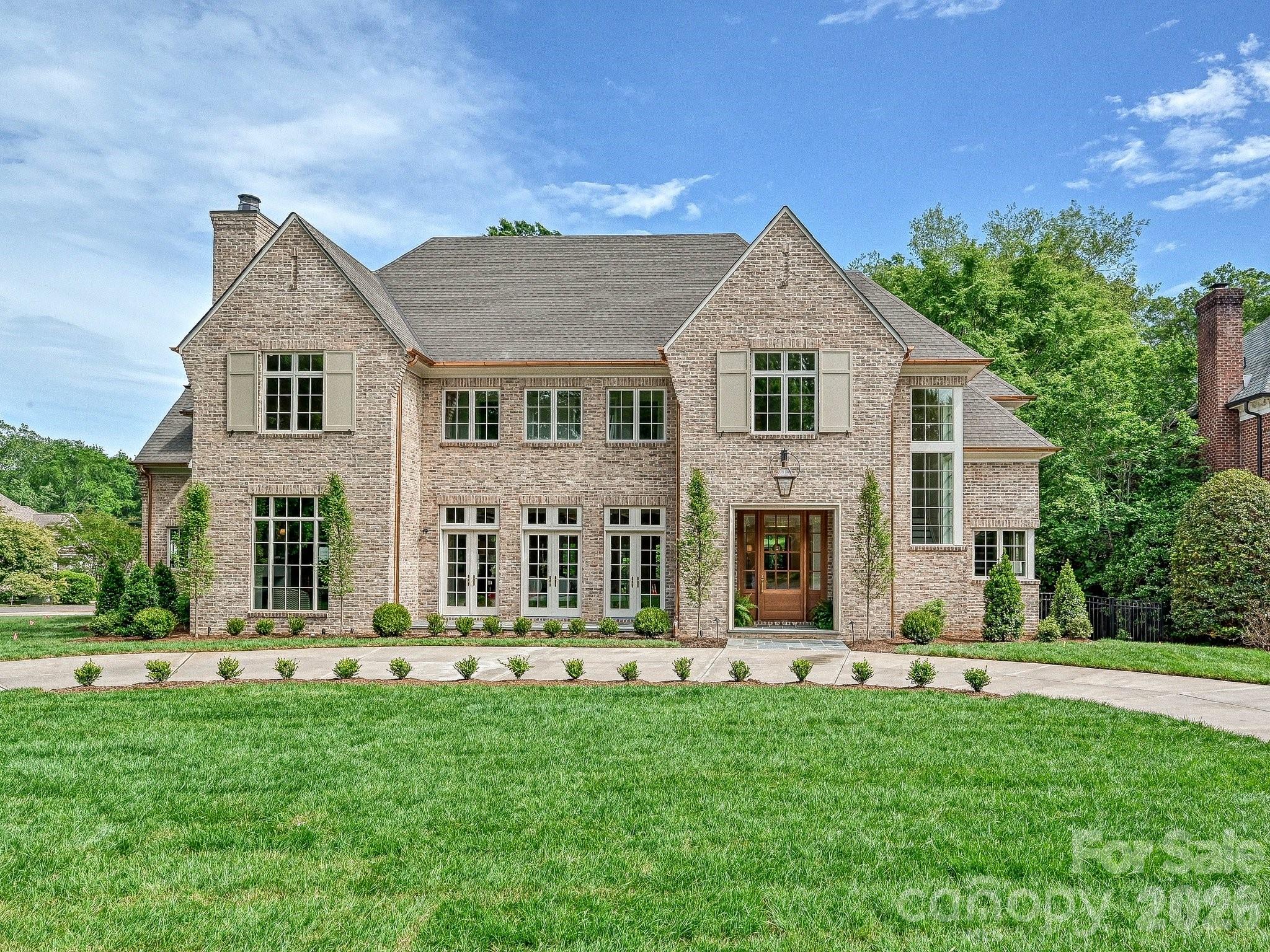 Exceptional Frank Smith design and Whittington Builders Carolina brick-built home offering a refined blend of timeless design and modern functionality. Gorgeous interior selections by Alexander Langley design. Built for everyday living and effortless entertaining, this residence features a well-appointed floor plan with expansive living spaces, a private study, and multiple gathering areas throughout. The chef’s kitchen is the centerpiece of the home, complete with a large island, custom plaster hood, and a full suite of luxury appliances, including Wolf, Sub-Zero, and Bosch. A separate scullery and walk-in pantry provide additional prep space and storage, ideal for hosting. The primary suite offers a private retreat with a spa-inspired bath and generous closet space. Additional highlights include multiple secondary bedrooms with en-suite baths, a dedicated wine room, fitness room, and both main-level and upper-level laundry. Outdoor living is equally considered, featuring a covered loggia with heaters, fireplace and grilling station overlooking the pool and spa, creating a seamless extension of the interior and ideal setting for year-round enjoyment. A curated, designer-selected palette and custom millwork carry throughout the home, creating a cohesive and sophisticated aesthetic.