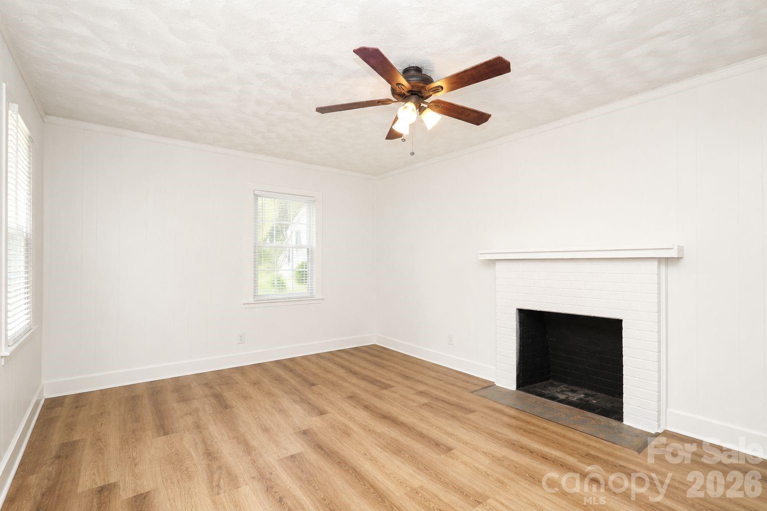 Solid, all-brick ranch with massive financial value and endless potential! Nestled on a private, tree-lined half-acre lot close to downtown Lancaster, this freshly painted 2-bedroom, 1.5-bathroom home has just been professionally deep-cleaned and is ready for its next chapter. Step inside to a bright living room with a cozy fireplace, a large eat-in kitchen with abundant cabinetry, and a flexible dining/sitting space. The primary bedroom features a unique connected bonus room—perfect for an oversized walk-in closet, home office, or nursery.

This home  Lancaster home also offers a full hall bath and a convenient half bath off the kitchen. Outside, relax in the private backyard surrounded by mature trees—perfect for outdoor entertaining, gardening, or pets. A covered 2-car carport and extended driveway with a turn-around provide easy parking and storage.

Located close to downtown Lancaster, schools, parks, and shopping, this home is ideal for buyers looking for comfort, convenience, and plenty of outdoor space in a quiet setting.  this home has an assumable mortgage through movement per the seller.