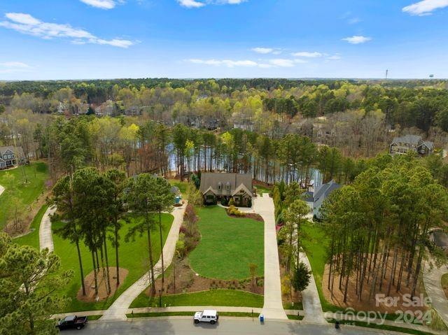 Welcome to waterfront luxury living at its finest! This custom-built home, completed in 2014, spans over 8100 sqft under roof. Designed with an open plan, the home features expansive spaces with lake views from numerous vantage points. The heart of the home, a magnificent 2-story great room, boasts a stone fireplace and a wall of windows, flooding the space with natural light. The chef's kitchen is a culinary delight, equipped with stainless steel appliances, gas cooktop, double wall ovens, a generous island with seating, and a butler's pantry with refrigerator drawer. The lakeside owner's suite is a sanctuary of relaxation, complete with an ensuite featuring dual vanities, heated tile floors, a soaking tub, and a walk-in shower. The walk-out basement offers additional entertainment options with a recreation area, bar, family room, and flex space with full bath/closet. Abundant storage for lake toys in the unfinished portion of the basement. The backyard has room for a pool.