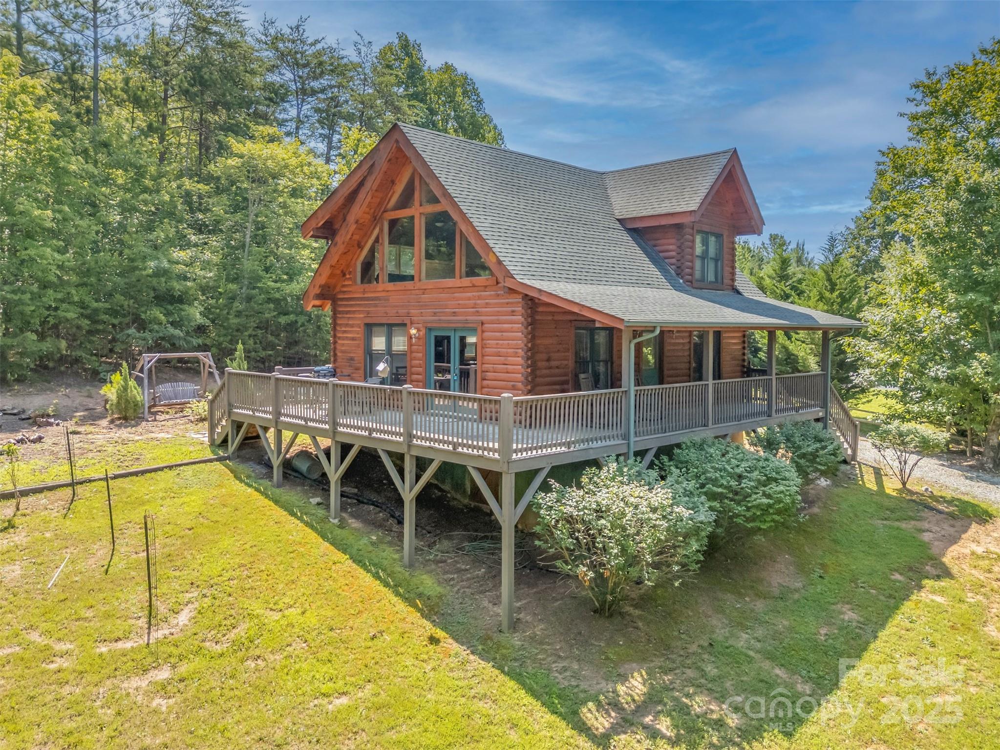 WARM & INVITING HOME NESTLED in mature hardwoods on 2 Acres, in the beautiful gated community of Hidden Lake. From the covered porch or deck into spacious living area with soaring ceilings & massive windows to enjoy beautiful outdoor scenery. Living area flows into dining area & well equipped kitchen. Main level also features bedroom & full bath. Up pretty stairway to the loft/multi use area w/ more massive windows, bedroom & large bath completed with separate shower & garden tub.  Beautiful hardwood floors flow throughout the home w/tile in kitchen & baths. Great amenities for all, including pool, hot tub, lake with canoeing, playground, picnic area, walking trails & year round community activities. Good time for everyone, whether it is a dip in the pool, evenings by the lake, events at the lakeside park or relaxing in the spa. Wonderful opportunity for full time resident, weekend retreat, smart investment allowing short term rentals, this log home provides the best of both worlds.