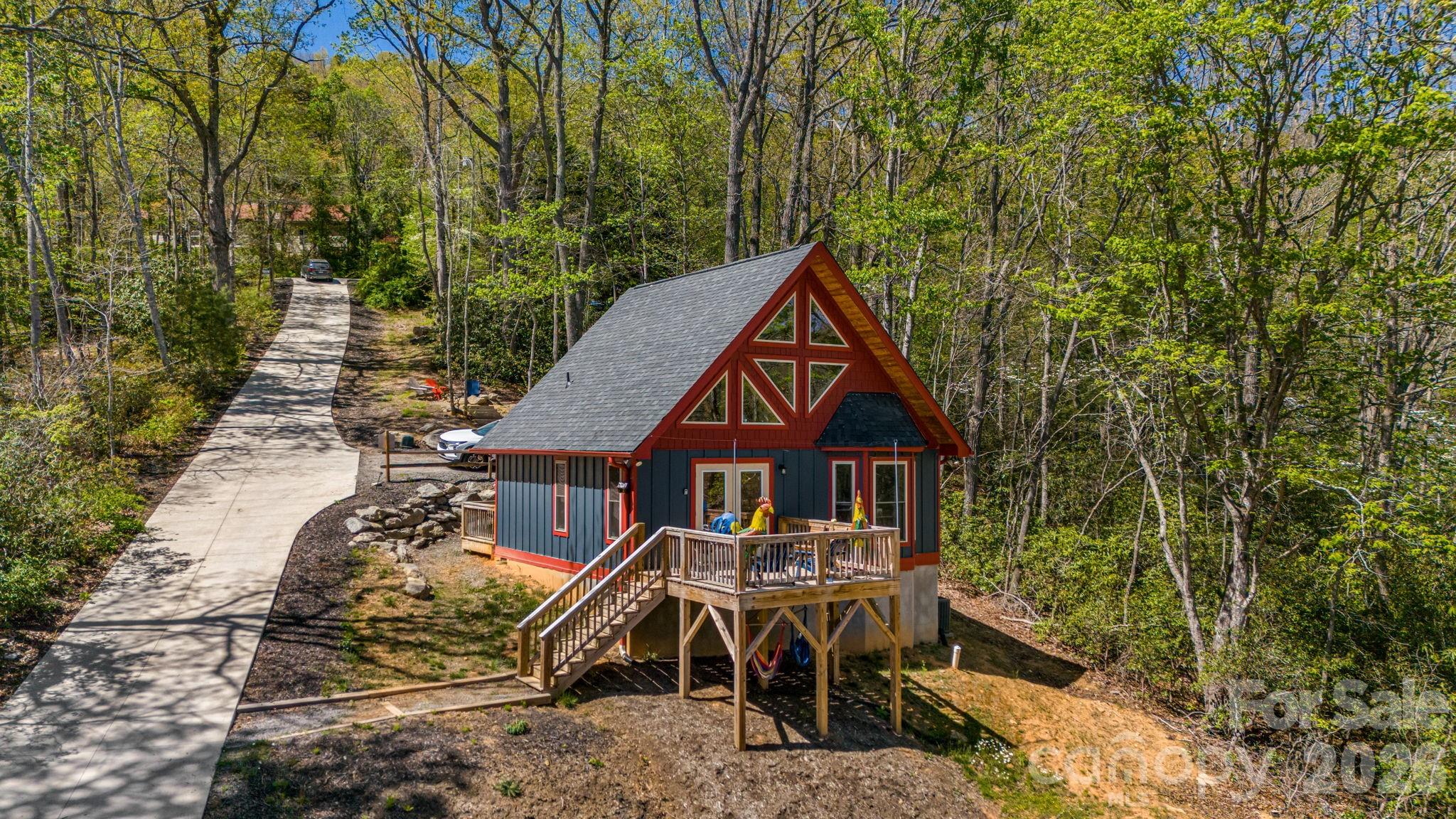 Two fully furnished homes set on 2.44 private acres along Flat Top Mountain Road—offering flexibility, income potential, and modern mountain living just minutes from Asheville. Currently operating as successful Airbnbs, this property is ready to step right into.

Built in 2023, the main home is a beautifully crafted log cabin featuring 3 bedrooms, 2.5 baths, and an open, light-filled floor plan with modern finishes that complement its mountain character. The second home offers 2 bedrooms and 1 bath—ideal for guests, multi-generational living, or continued rental income.

Both homes feature upper-level loft bedrooms open to the main living spaces, creating a warm, airy feel. Positioned to maximize privacy while still functioning as a cohesive property, the layout allows for multiple uses—live in one and rent the other, host family and friends, or continue operating both as income-producing properties.

The 2.44-acre setting provides usable outdoor space and a peaceful mountain backdrop, with an additional lot included for future flexibility or expansion.

Property infrastructure includes a 5-bedroom septic system with two separate tanks sharing a drain field, along with a shared well.

Turn key, versatile, and ready to go—this is mountain property that gives you options.