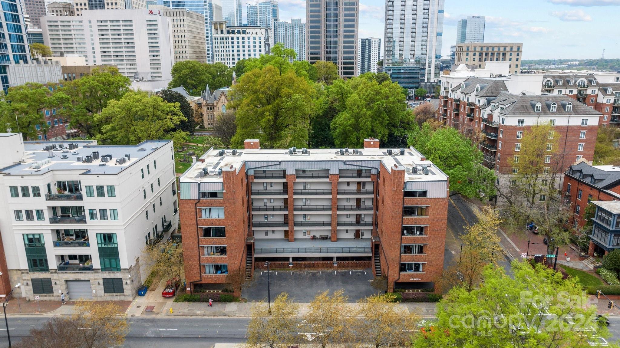Welcome to Churchill, a rare gem nestled between Uptown and Fourth Ward in vibrant Charlotte. This fabulous condo offers an unbeatable location, just moments away from the energy and excitement of center city. Step into this open concept one-bedroom, one-bathroom unit and be greeted by its charming ambiance. The cozy fireplace adds a touch of warmth, creating a cozy atmosphere. Enjoy breathtaking views of the uptown skyline and the park across the street from the private, spacious balcony. Convenience is key with a grocery store and drugstore nearby.  One deeded parking space included, and plenty of guest parking is available in front of the building. The elevator and common areas add to the ease of living in this desirable community. Don't miss out on this rare opportunity to own a piece of uptown Charlotte. Experience the fantastic food scene, entertainment options, and all the amenities this vibrant city has to offer.