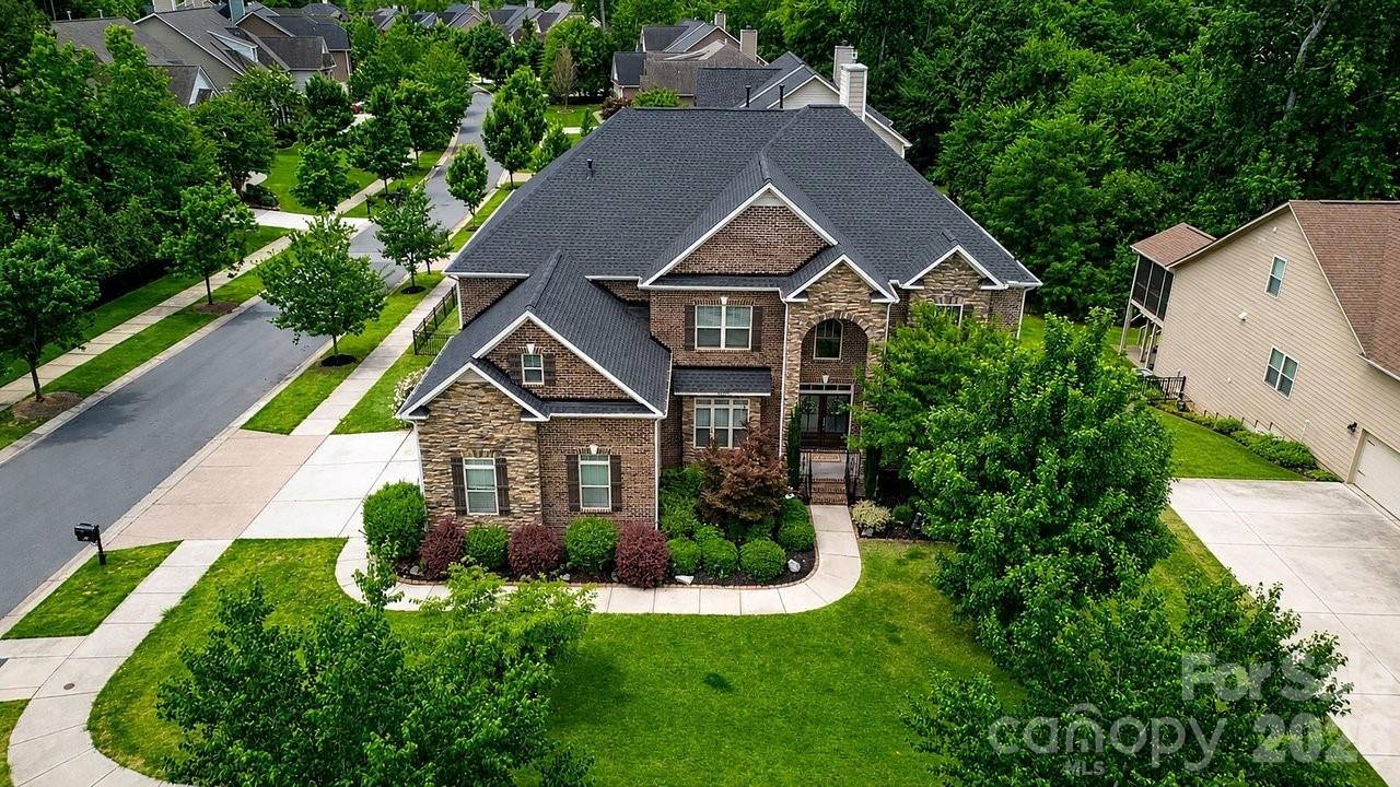 This one will check all the boxes plus more! Location, amenities, space, beauty, functionality, and concessions to personalize the home as your own. Welcome to 16032 Loch Raven Road Huntersville North Carolina. This stunning 6-bedroom, 5.5-bathroom home will capture your attention from the moment you drive up. The warm, rich curb appeal of this corner lot home will make you want to come inside. Once inside, the beauty will draw you to make it your own. You will soon see that no attention to detail was left behind in design and functionality; from the Westinghouse whole home water refiner, kitchen sink reverse osmosis water filter, pot filler, two 50-gallon tank gas water heaters, gourmet kitchen double over, side-mount double garage door that allows for overhead storage or a car lift, and so much more. The sunroom off the massive two-story grand living room is a place of peace and relaxation. The basement level is a finished canvas of opportunity for multigenerational living, a professional home theater, a full-sized personal gym; the possibilities are endless. This beautiful home, full of love, is just a short distance from all that Main Street has to offer.  Schedule your showing today before it’s too late!!
(Home faces 38 degrees NE)