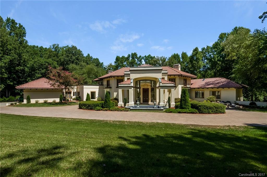 5.25 Acre residence offers stunning architecture. The grans entryway with prominent porte-cochere and floor to ceiling 22ft windows and sky lights. brighten the feel of the homeland offer beautiful views. Home is nestled in Charlotte's best kept secret, purposefully discreet min 5 acre gated Greenwood off Providence Rd.  This level of privacy is unparalleled this close to uptown and South Charlotte.