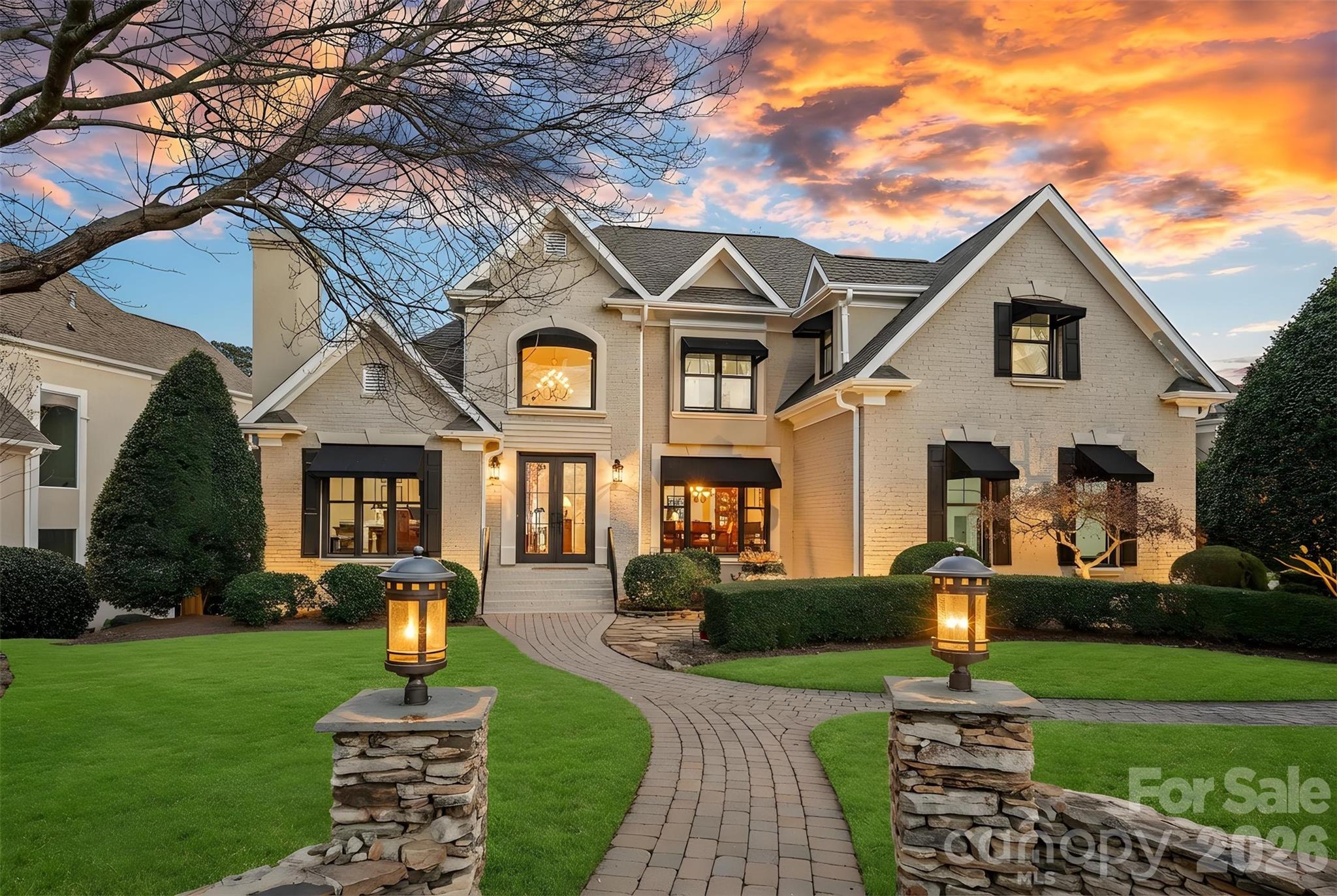 Stunning waterfront retreat in The Peninsula, this exquisite home spans three levels of luxurious living and embodies serene lakefront elegance. The main-level primary suite offers convenience and accessibility, while a sunroom bathes the interior in natural light and frames captivating lake vistas. Thoughtfully updated bathrooms, refinished hardwood floors, new fiberglass windows and doors, updated mechanicals, and fresh paint throughout elevate every space, complemented by three fireplaces adding warmth and ambiance. The lake level features a fully equipped kitchen and bar, ideal for entertaining or enjoying tranquil evenings by the water, alongside an updated second primary suite for guest comfort and privacy. Step outside to the pergola and immaculate landscaping, seamlessly blending with the waterfront setting. A deeded boat slip provides effortless access to water recreation. Additional updates have been made to enhance this already exceptional home, ensuring both style and comfort for years to come.