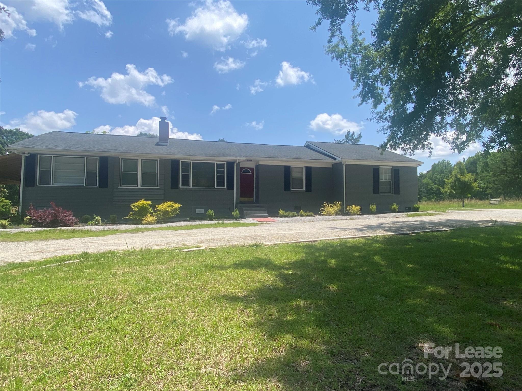 Bright open lot, Roof extended on back of house for storage of landscaping equipment, bikes, or ATV. Lot is 7.20 acres with open area and pond.