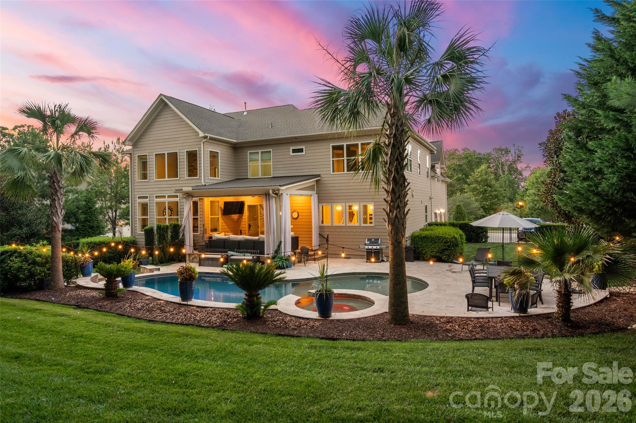 From the moment you arrive, this exceptional 6-bedroom, 5-bath home invites you to slow down and stay awhile—relax on the welcoming front porch and take in the peaceful surroundings. Inside, dramatic architecture, an open floor plan, and views of the spectacular resort-style backyard create an unforgettable first impression, all within the sought-after Marvin school district. Step through custom double doors to a dramatic dual curved staircase and light-filled living spaces. Engineered wood floors flow throughout the main living areas, and a designer stair runner adds a sophisticated touch. A guest suite on the main level offers comfort and privacy for visitors.  At the heart of the home, the soaring two-story great room features a striking floor-to-ceiling stone fireplace, abundant windows, and remote-controlled blinds.  Open to the family room, the beautifully appointed white kitchen is designed for effortless entertaining, including a 10' island!  A butler's pantry with wine refrigerator and large walk-in pantry provide exceptional storage and convenience. Upstairs, the expansive primary suite is a true retreat, complete with a private sitting area, an amazingly spacious primary bathroom, and a custom-built dream closet with exceptional storage and organization.  Step outside to your own private resort, where a heated saltwater pool, hot tub, fire pit, and covered veranda create the perfect setting for relaxing and entertaining year-round. The 3-car garage adds even more functionality with epoxy-coated floors, drop-down storage, a workbench, and extensive cabinet storage. With dramatic architecture, abundant natural light, thoughtful upgrades, and exceptional indoor-outdoor living, this remarkable home offers an unforgettable combination of elegance, comfort, and functionality.