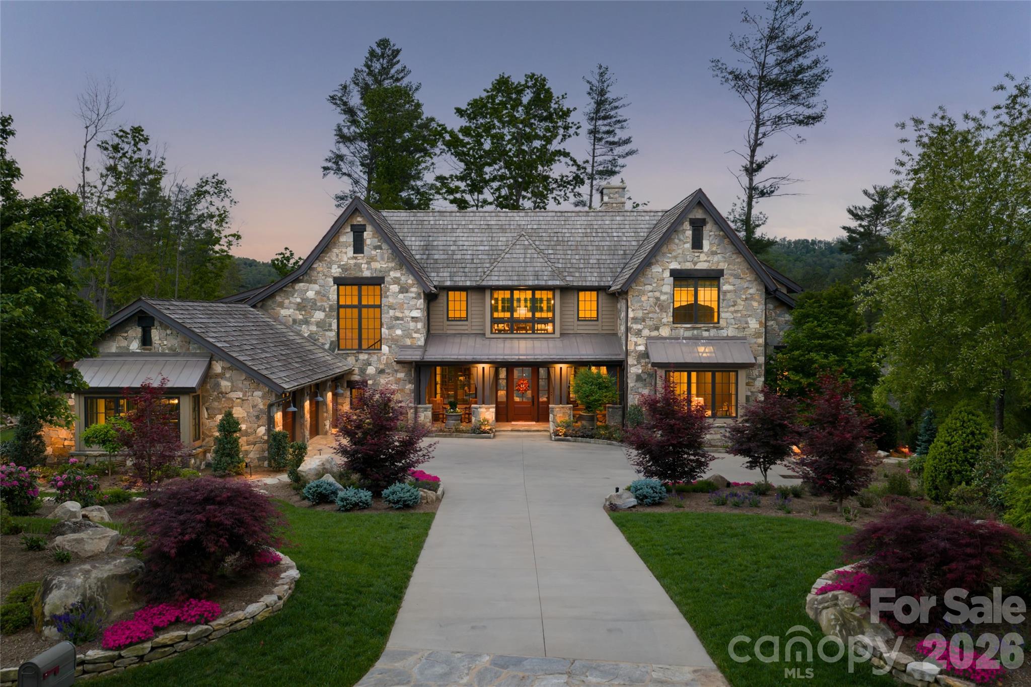 Tucked within one of Asheville’s desired luxury communities, 18 Fairsted Drive is a premier example of high-end mountain modern living, where exceptional craftsmanship, curated materials and intentional design define every space. Originally built by the owner of Jennings Lumber, this custom luxury home showcases an extraordinary use of reclaimed wood throughout, from mixed-width oak flooring and hand-selected barnwood beams to bespoke cabinetry and architectural detailing, creating a warm, timeless aesthetic rarely found in newer construction. Designed by Platt and built by Thompson Properties, this 5,200-plus square foot estate offers four bedrooms, a dedicated office, and 5.5 baths with a seamless blend of luxury finishes and modern functionality. The open-concept main living area features soaring double-height ceilings, a natural stone fireplace and expansive NanaWall glass doors that create effortless indoor-outdoor living, one of the sought-after features in Asheville luxury real estate. Premium upgrades include Lutron lighting, automated Hunter Douglas shades, Kolbe aluminum-clad windows, and integrated audio that elevate comfort and convenience. The chef’s kitchen is designed for everyday living and entertaining, centered around an oversized reclaimed wood island with honed granite countertops. High-end appliances include a paneled Sub-Zero refrigerator, Thermador 48-inch gas range, double ovens, and dual Kohler farmhouse sinks. Custom inset cabinetry, a reclaimed wood and metal vent hood, and a fully equipped scullery/pantry provide additional prep space and storage, ideal for luxury home buyers seeking style and performance. The main-level primary suite offers a private retreat with vaulted ceilings, custom millwork, and spa-inspired finishes including a steam shower, jetted soaking tub and dual vanities. Each guest suite features vaulted ceilings and en-suite baths, providing comfort and privacy for family and guests alike. Outdoor living is a highlight of this Asheville luxury property, with professionally designed landscaping and hardscaping that rivals a private resort. The fully fenced backyard features a cascading stone waterfall with built-in seating, a dramatic flagstone water wall and a gas fire pit, ideal for entertaining or relaxing year-round. Covered outdoor living areas include retractable screens, built-in heaters and media, making this home ideal for enjoying Western North Carolina’s four-season climate. Within the gates of The Ramble Biltmore Forest, one of Asheville’s prestigious gated communities, residents enjoy access to over 1,000 acres of preserved land, scenic recreational trails, parks and luxury amenities. The community features a wellness center, resort-style pool, tennis courts and the Living Well Center, all just minutes from Biltmore Village and downtown Asheville, known for its award-winning restaurants, shopping and vibrant arts scene. With a cedar shake roof, solid wood garage doors, 36-kilowatt Generac whole-home generator and top-tier mechanical systems, every detail of this home reflects quality construction and long-term value. Offering main-level living, integrated smart home technology and exceptional indoor-outdoor flow, this luxury residence represents one of the most compelling opportunities in the greater Asheville luxury market. 18 Fairsted Drive is a rare opportunity to own a luxury home in Asheville that combines elevated design, premium materials and an unmatched lifestyle in The Ramble Biltmore Forest.