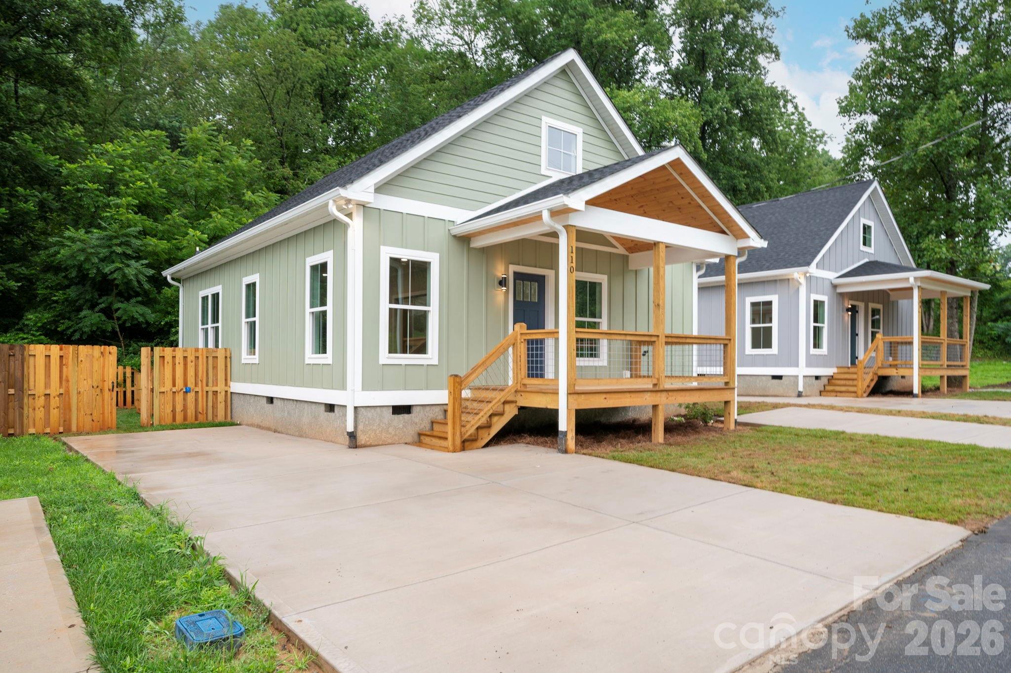 110 Orchard Street Adventure and affordability meet just 20 minutes from Asheville! This newly built 2BR/2BA home in Old Fort puts you steps from trailheads, cycling routes, and local dining and breweries - perfect for active living or a weekend escape. Flexible live/work or small professional use adds versatility beyond a traditional residence. Finished in crisp white board-and-batten, the home features a functional layout, city water/sewer, covered front porch, back deck, stand-up attic, privacy fence, and dual off-street parking. A charming small stream adds natural ambiance, while the low-maintenance yard keeps life simple. The property also offers short- or mid-term rental potential in a supply-constrained market. Owner/broker. Exterior highlights include: Covered front porch Private back deck Fully fenced yard Easy-care, level lot Large driveway for plenty of parking Located in the heart of Old Fort, you’re just a short walk or ride to local restaurants, breweries, and shops — and only 20 minutes to Asheville. No HOA. STR-friendly. Broker-owned.