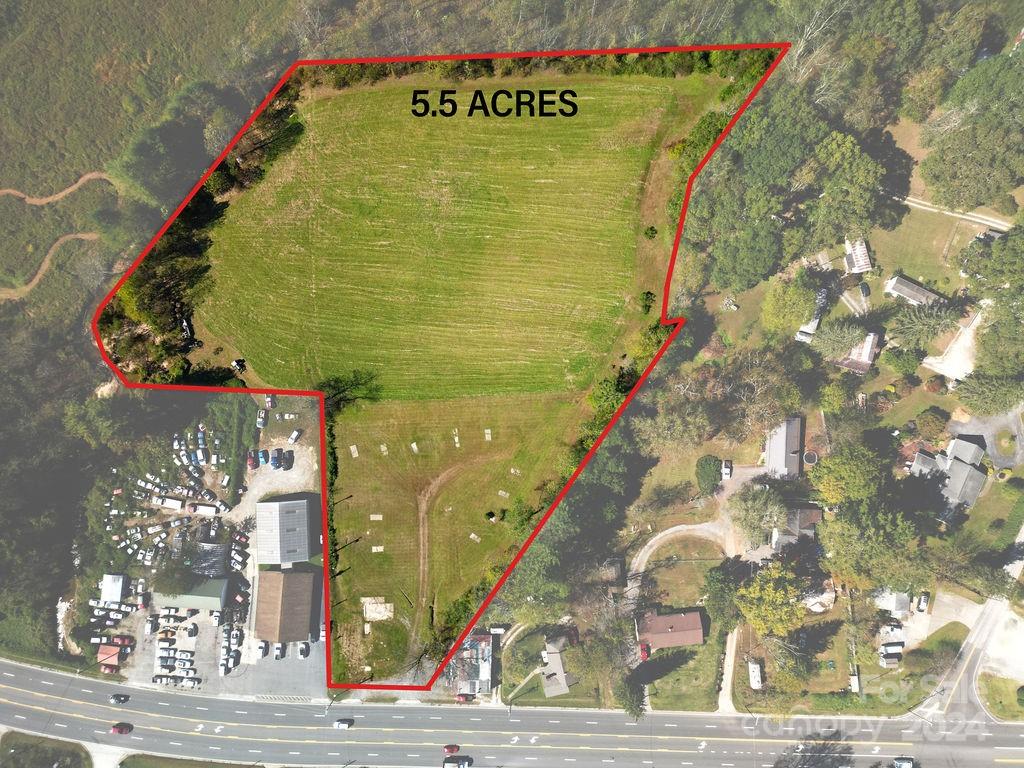 Roughly 1 mile from Main Street Brevard on US Hwy 64, this 5.5 acre parcel has endless possibilities. Made up of two parcel numbers, the first parcel is 1.39 acres, has 115 feet of frontage on the four lane highway, and is zoned Neighborhood mixed use. The other parcel is 4.11 acres, zoned residential G4, level, cleared, and has 424 feet of frontage on Nicholson Creek. It is all in the ETJ. If you are looking for a highly visible commercial parcel on a road with a high traffic count, close to downtown, plenty of room for a storage yard or expansion in the back, and easy access, this might be the one. It would also make a great parcel for a development. This parcel offers many avenues to make it an income producing property. It is a must see.