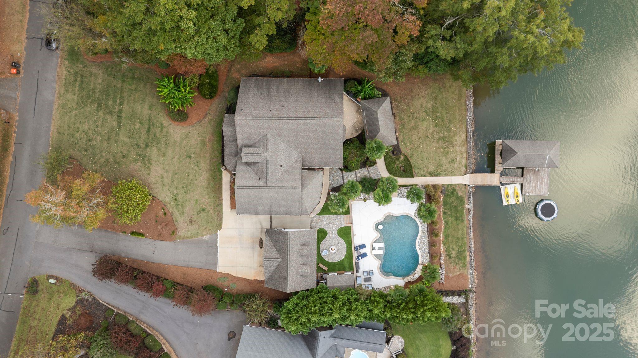 Welcome to Maison Oak — Where Southern Living Meets Lakeside Luxury.

Set on an exceptionally level, usable lakefront lot, 141 feet of shoreline, approximately 5-7ft in water depth; this remarkable property captures the essence of waterfront living — from morning serenity to sunset reflections over Lake Wylie. Every inch of the home has been reimagined with luxury, comfort, and lifestyle in mind.

Enjoy a NEW Blue Haven saltwater, gas-heated(faster) pool with waterfall, swim-up bar/table seating, and OmniLogic smart automation for pool controls — perfectly complemented by the floating dock, boat lift, covered dock, and kayak launch. New professional landscaping, premium turf, and hardwired landscape lighting creates a dramatic evening ambiance that you can enjoy from the boat, pool, outdoor patio, the main level floor to ceiling windows, or from the primary suite's private covered balcony! Views are the most important here at Maison Oak.

Inside, you’ll find timeless craftsmanship and thoughtful updates throughout: all-new Hardie Board exterior siding, NEW dual HVAC systems, freshly sanded & painted interiors, and new LVP flooring in the basement. The lower level offers an additional kitchen and oversized island, a laundry, and home theater — ideal for entertaining or secondary living space.

Retreat to the primary bedroom with its en-suite bathroom, two custom walk-in closets, and unwind by the Breeo smokeless fire pit, or launch into the lake from your boat lift or kayak launch. With a whole-home water softener, new shiplap accents, and a new retaining-wall that invites effortless outdoor living, Maison Oak is more than a home — it’s a statement of Southern luxury, connection, and pride!