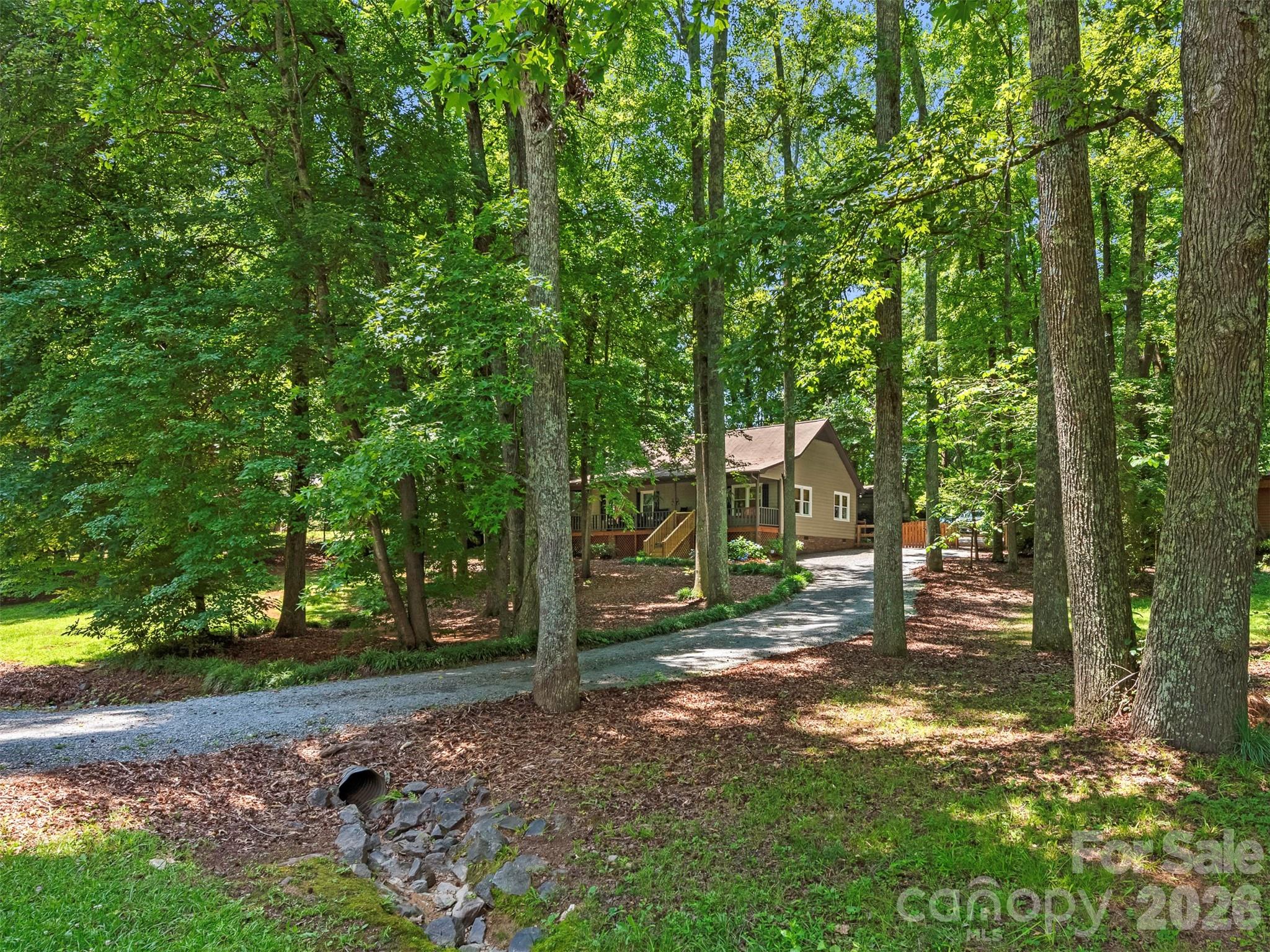 Quaint and cozy 3-bedroom, 2-bath ranch home located in the highly sought-after Matthews/Stallings area. Nestled on a private wooded lot in the desirable Enchanted Forest community with no HOA, this charming home offers peaceful surroundings, a fully covered rocking-chair front porch, and a secluded backyard with privacy fencing and gate. Ample parking is available, including an expanded gravel parking area, and the location provides convenient access to I-485.

The home has been thoughtfully updated over the years. The kitchen was renovated in 2023 and features custom cabinetry, butcher block countertops, a stylish backsplash, and new appliances, including the oven and refrigerator. The main bathroom was completely remodeled in 2023, and the primary closet was converted into a second full bathroom the same year. Additional improvements include updated light fixtures throughout, crawl space encapsulation with a dehumidifier installed in 2017, replacement windows in 2015, a water heater installed in 2014, and a roof replacement in 2010.

The primary bathroom, main bathroom, and laundry closet renovations were completed in 2023 by a renovation company in collaboration with the owner. A detached garage/workshop, added by previous owners, provides additional storage and workspace. No permit records have been located for this structure. The garage/workshop is being sold as-is, is not sealed, and features a manually operated garage door.

This move-in-ready home offers a rare combination of privacy, character, and convenience. Don't miss the opportunity to make it yours.