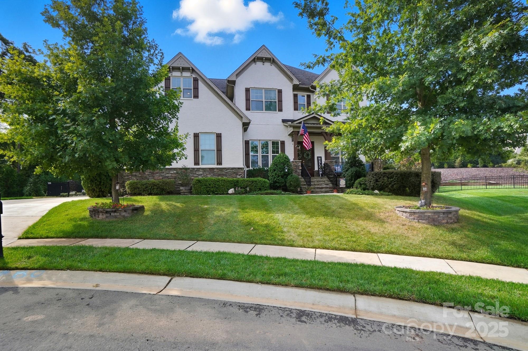 Price reduced!! Stunning retreat with resort-style pool in prestigious Lake Ridge Manors section. Tucked away in a quiet cul-de-sac within one of the area's most desirable upscale neighborhoods, this exquisite home offers luxury living both inside and out. From top-rated schools to unmatched community amenities, every detail has been designed for comfort, convenience, and elevated living. Step into an open-concept floor plan where natural light fills every corner, highlighting elegant finishes and seamless flow—perfect for both everyday living and entertaining. The main level features a private guest suite, ideal for visitors or multi-generational living, while upstairs you'll find four spacious bedrooms, including a serene owner’s suite. Outdoors, escape to your own private paradise. The custom-designed pool is a showstopper, featuring a built-in hot tub, tranquil waterfall, and expansive patio space for lounging or hosting all on a large 1/2 acre lot leaving ample yard space and grassy areas for the kids to play. A screened porch and stylish pergola complete the ultimate backyard oasis—perfect for year-round enjoyment. Sellers have invested over $350,000 into the pool, pergola, screen porch, patio areas, fencing and landscaping to make this a true oasis. Residents enjoy access to resort-style community amenities, including a pool, clubhouse, fitness center, tennis courts, scenic walking trails, and playground. This is more than a home—it’s a lifestyle. Don’t miss the opportunity to own this extraordinary property in a prime location. Schedule your private tour today!