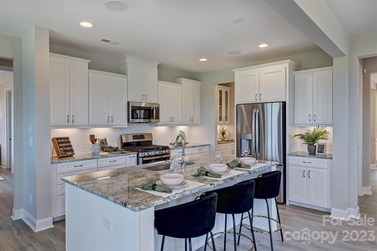 MLS # 4064554 REPRESENTATIVE PHOTOS ADDED. The Essex plan a perfect choice for homeowners who value A+ curb appeal. This home features a welcoming entrance. Usher guests down the hall to the stunning open-concept gathering room or park yourself in the roomy study.  Love where you cook in your gourmet kitchen that includes a large food prep island, expansive countertop space, and walk-in pantry. Guests will certainly enjoy their stay with the guest suite bedroom located on the first floor. Upstairs features  three additional bedrooms and a truly remarkable owner’s suite. It’s hard to imagine a more complete setup with a tub and shower, dual vanities, massive walk-in closet and entrance to laundry room. Structural options include: gourmet kitchen, tray ceiling, bedroom in lieu of game room, study, 4' gathering room extension, shower ledge at owner's shower, covered outdoor living, gas fireplace, laundry sink, door from owners closet to laundry room, and butlers pantry.
