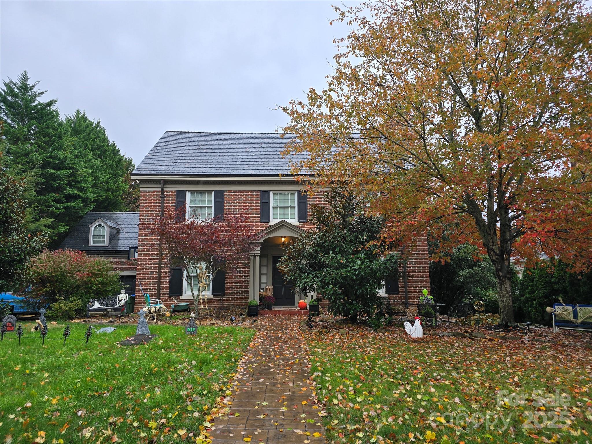 Own a piece of Asheville history on one of Grove Park’s most beloved and iconic avenues, just minutes from downtown. Originally commissioned by Caleb Smith and designed by noted architect Ronald Greene, this Colonial Revival masterpiece blends timeless craftsmanship with modern convenience. Enjoy unobstructed views of the Grove Park Inn, Donald Ross golf course, and Sunset Mountain from three levels of entertaining decks, brick patios, and fenced backyard with room to play—and even a charming chicken coop for those seeking a touch of Asheville authenticity. Inside, the home features a gourmet kitchen with Thermador appliances, Sub-Zero refrigerator, a Butler’s pantry, and French doors that open to an expansive deck overlooking the golf course. The spacious primary suite offers an elegant bath, a newly added huge walk-in closet, and serene views. Five large bedrooms, an office with built-ins, and generous storage throughout—including 11 closets and six storage rooms—ensure comfort and functionality at every turn. The fully finished walk-out lower level, with a private entrance, includes a family room, second kitchen, laundry, bedroom, and bath—ideal for guests, multi-generational living, or possible Airbnb potential. Above the detached garage, a private studio with bath and newly installed flooring, provides excellent flex space for guests, hobbies, or a home office. Additional highlights include a slate roof, copper gutters, restored sidewalk along the Grove Park Inn golf course. Listed on the National Register of Historic Places, this home embodies the perfect balance of history, beauty, and modern livability in Asheville’s most sought-after neighborhood.