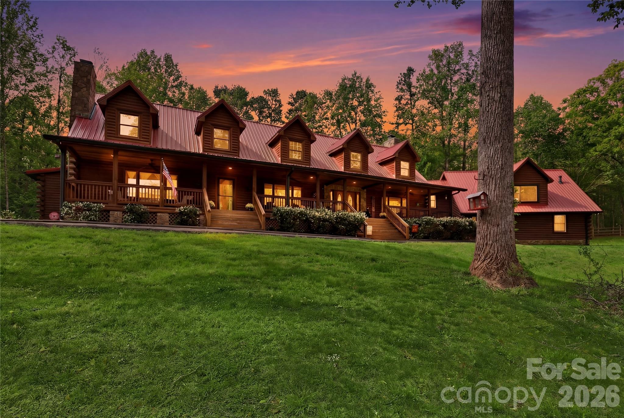 Tucked behind a private gate and set far from the road along a winding drive, 12300 McCord Road in Huntersville offers a rare blend of peaceful seclusion and timeless rustic charm. Nestled on 11.27(+/-) acres of serene, wooded beauty, this remarkable property invites you to slow down, breathe deeply, and experience true country elegance—just minutes from modern conveniences.
This stunning 6,033 sq ft Custom Built Log Cabin home is thoughtfully designed with both comfort and character in mind. Featuring 7 spacious bedrooms and 4 bathrooms and 2 1/2 baths, including a 2nd living quarter with access from the home and garage. 
At the heart of the home, the gourmet chef’s kitchen featuring a Viking Gas Stove and oven, is a true delight—crafted for both everyday living and entertaining, with ample space, high-end built-in finishes, and a welcoming atmosphere that makes every meal feel special.  Large center prep island with its own sink & beverage fridge, and plenty of room for seating at the island.
Enjoy the large great room with beautiful built-ins and gas fireplace where you can gather and watch your favorite movie on the large screen, just add the popcorn!
Primary Bedroom is its own suite with gas fireplace and its own door to the gorgeous porch that expands to the front of the home, perfect for a cup of coffee in the morning or enjoying the sunset in the evening.  The primary bedroom offers its own ensuite with a see-through gas fireplace between the spa-like walk-in shower, built-ins in the changing room + walk in closet and 2nd closet.  Just off the primary ensuite/changing room is a work-out room with multi functioning for many options.
Step outside through the sunroom just off the great room to your own private retreat, where a beautiful in-ground pool with a cascading waterfall and relaxing hot tub awaits.  The sunroom is a wonderful place to unwind from a day outside, this stunning room includes a kitchen, and 1/2 bath that has a door to come in from the pool. 
Upstairs, a spacious living/game room offers endless possibilities—whether for recreation, media, built-in wet bar, or a private escape to the expansive deck that overlooks the pool. 
Just down the hall is 2 more bedrooms, full bathroom and large laundry room with plenty of cabinets and folding counter.
Step down into the additional 2nd living quarters, featuring a spacious 2nd living area that leads you into the 2nd living quarters, where you will find a full bathroom, 2 bedrooms and a large living area with gas fireplace, kitchen, and room for an office.
The home is complete with a 2-car garage with ample extended space and breezeway between garage and home with access to the garage from the 2nd living quarters from within the home. If you are looking for a place to tinker, the garage also has a workshop area and an additional laundry room with washer and dryer.  Additional large storage room a rear of home near pool entrance.
This RARE GEM in Huntersville offers an abundant room to roam, explore, and enjoy the beauty of your own land.
From the gated entrance to the peaceful acreage beyond, this property is more than a home—it’s a lifestyle of privacy, charm, and rustic luxury, paired with incredible potential in one of Huntersville’s most desirable settings.
TR Zoning has been approved by the Town of Huntersville for future/potential vision.