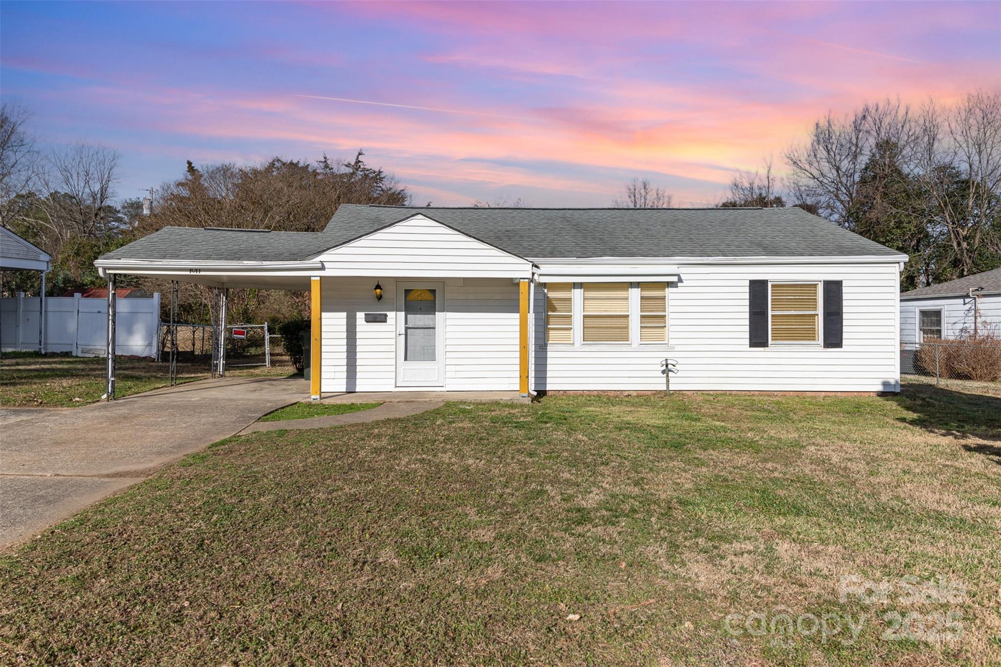 Adorable bungalow home in Catawba Terrace. Close proximity to downtown Rock Hill, shopping, dining and Winthrop University. Enter through the front door to the cozy yet spacious living room which opens to the dining room with built in storage. Three bedrooms include ceiling fans for extra comfort. Kitchen offers a generous amount of cabinet and countertop space, new dishwasher and range in 2025. Laundry room adjoins the kitchen with matching cabinets for even more storage. New vinyl plank flooring just over a year old. Fresh, neutral paint throughout. Large fully fenced in back yard with a shed for extra storage. Attached carport and plenty of driveway space.