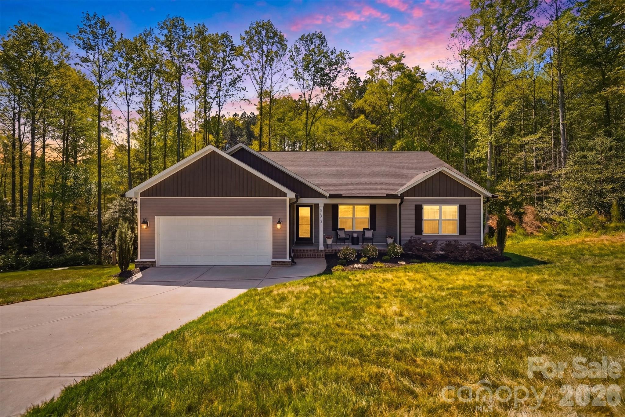 Located in the desirable Grace Chapel area of Caldwell County, this meticulously maintained 3 bedroom, 2 bath ranch offers move in ready comfort for its next owners! Nestled on a generous 1 acre lot in a peaceful cul-de-sac near Lake Hickory, the home features a serene, private wooded backdrop, beautiful landscaping & a charming covered front porch. Inside, you’re welcomed by a bright, open layout filled with natural light, enhanced by fresh interior paint & luxury LVP flooring throughout the main living areas. The living room features a vaulted ceiling, adding height & character while creating an inviting space to gather. The split-bedroom floorplan provides privacy & ideal for all! The oversized primary bedroom features a cathedral ceiling & a spacious walk-in closet. The primary bath includes dual granite vanities & a tub/shower combination. The two additional bedrooms are generously sized & share a full bath with a granite vanity and tub/shower combo. Exterior features include a cozy back deck, perfect for morning coffee or evening reading & a tall crawlspace offering excellent storage options. Enjoy peaceful living in a scenic setting just moments from Lake Hickory, with convenient access to HWY 321 & only a short drive to Blowing Rock, offering the perfect balance of comfort, setting & accessibility. Schedule your tour today!