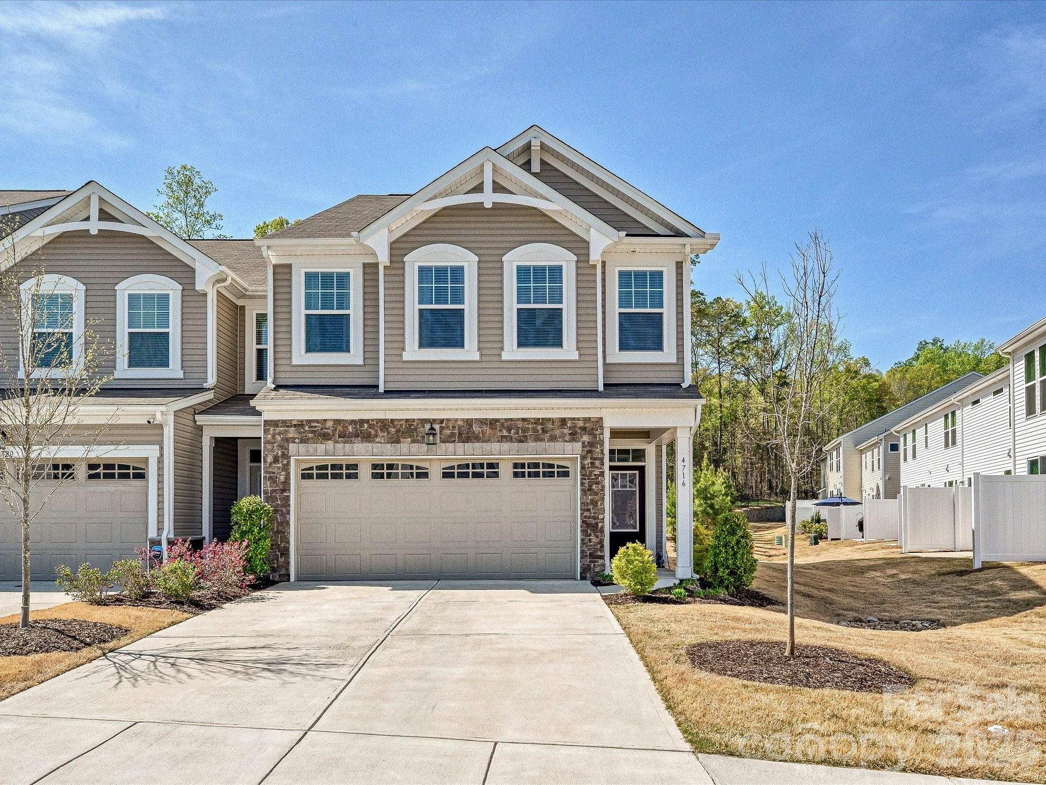 Sparkling newer end unit townhome in a prime location near shopping and Ballantyne! Great floor plan and loads of upgrades including LVP flooring main level, 9 foot ceilings main level, large kitchen w island, upgraded countertops, tile backsplash, upgraded lighting, microwave and pantry, spacious GR w ceiling fan and FP, central staircase w wrought iron balusters, Primary BR w trey ceiling, huge walk-in closet and BA w separate shower, and garden tub plus upgraded countertops, tile flooring and double vanities, 2 large secondary BRs w ceiling fans, one with a walk-in closet, 2nd floor oversized laundry room w overhead storage cabinets, blinds on all windows, 2 car GA w owner added storage shelving! Rear patio and private wooded back yard.