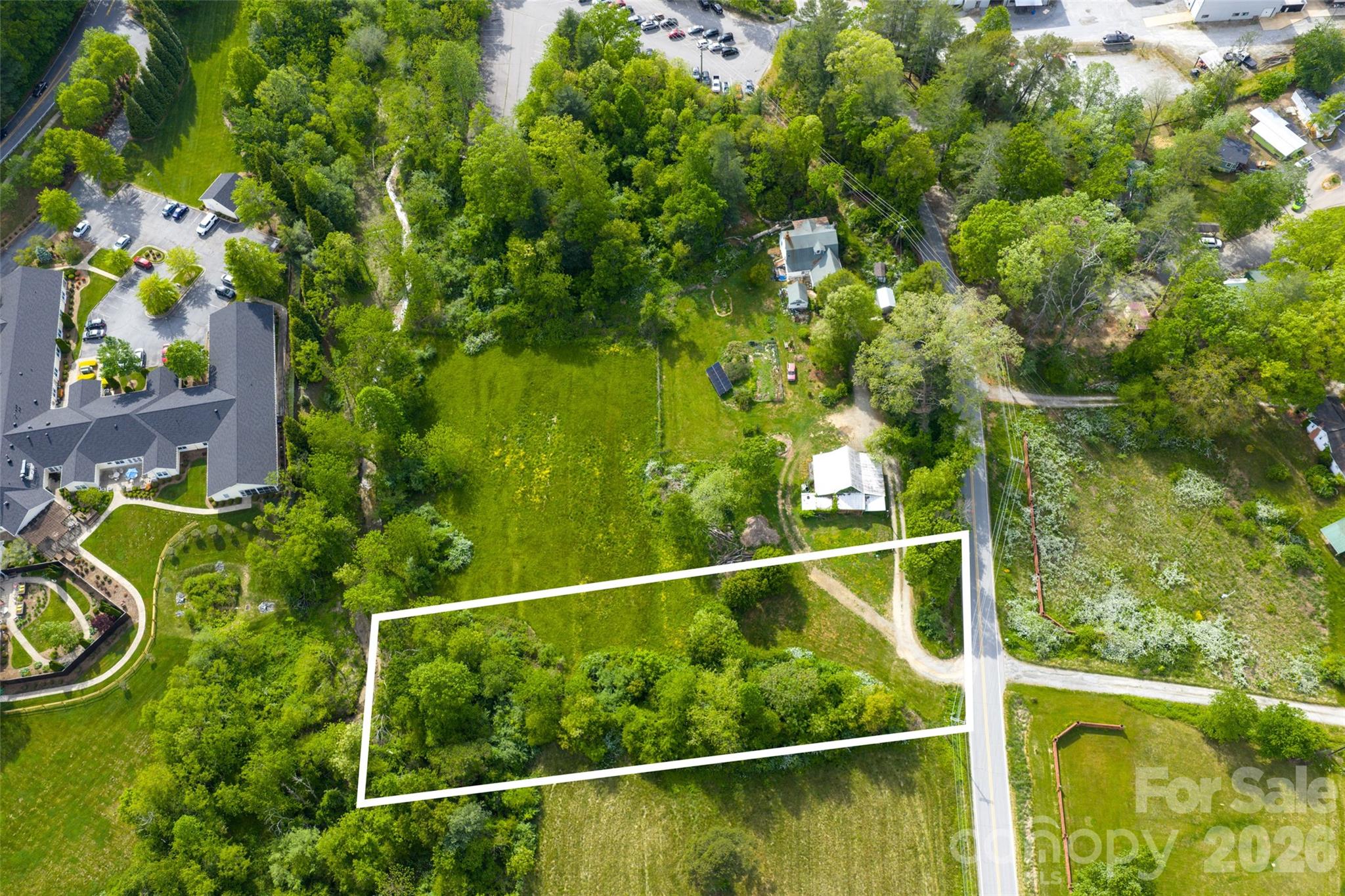 Tucked away in a peaceful, country setting yet just minutes from everything Henderson County has to offer, this approximately one-acre parcel presents a rare opportunity to create your ideal mountain retreat. The land is flat, usable, and appears well-suited for building—making it an excellent option for a primary residence, second home, or investment property.
This property offers the convenience of access to city water and electricity, along with a successful perc test already completed for a septic system (not yet installed), giving you a strong head start toward building.
With no known restrictions, the possibilities here are wide open—including potential for subdivision (buyer and buyer’s agent to verify with Henderson County zoning). Whether you’re envisioning a private homestead, a small development opportunity, or a peaceful getaway, this property delivers the best of both worlds—quiet surroundings with easy access to shopping, dining, and everyday conveniences in town.