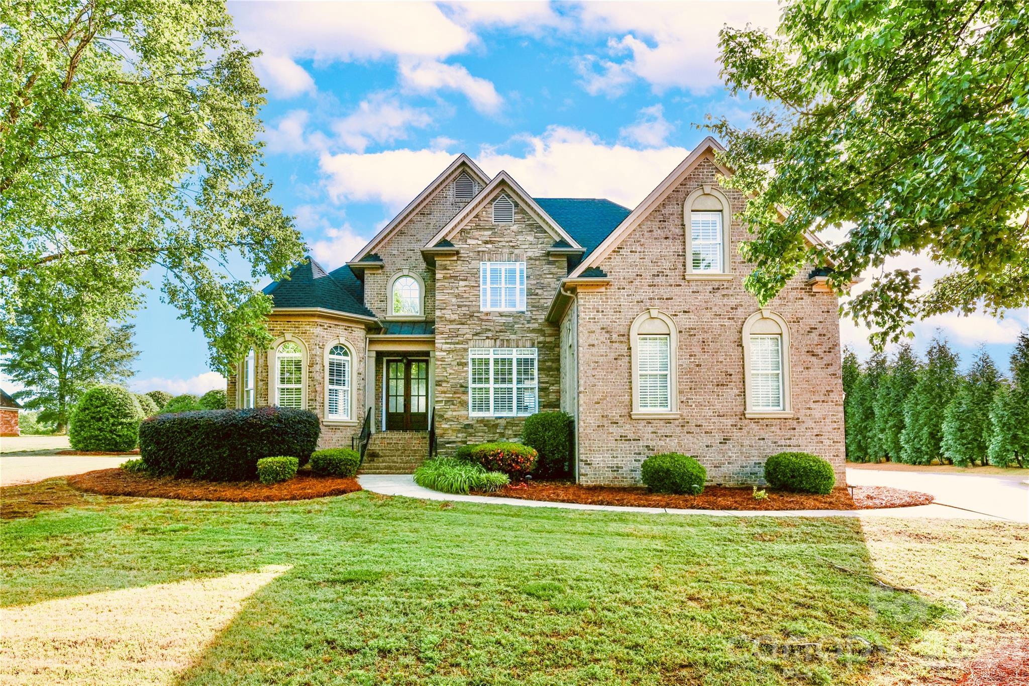Welcome to 4917 Campobello Drive, a beautifully updated home on a quiet inner-circle lot. This property perfectly blends a fresh, modern interior with a backyard designed for relaxing and entertaining. The functional floor plan features 4 bedrooms and 3 baths. The main level includes a family room, a keeping room, and a recently renovated kitchen with a comfortable sitting area and quartz countertops. The kitchen is a chef’s dream, featuring a custom coffee and wine bar with a beverage/wine fridge, along with premium Monogram appliances: an induction cooktop, steam oven microwave, and a convection oven with air frying capabilities. This level also features a downstairs primary bedroom with its own private sitting area and an ensuite bath with a Jacuzzi jetted tub and separate shower. An additional downstairs bedroom provides the perfect setup for a home office or guest suite. Upstairs, you will find two bedrooms and a spacious finished room over the garage. The home is filled with custom built-ins and classic plantation shutters throughout, while the garage is finished with a showroom-style epoxy floor and a Tesla EV charger. The backyard is the standout feature. Tucked away with mature trees for privacy, the property borders five acres of protected common area, providing massive, unobstructed views. It is a complete outdoor living space with a recently refurbished Anthony & Sylvan pool, a back patio, and a fire pit with bench seating. The custom cabana includes a full outdoor kitchen, a gas grill, a separate side gas burner, a gas equipped fireplace, sink and a new beverage fridge, making it easy to enjoy the outdoors all year long. With a recently replaced roof and a recently replaced multi-zone TRANE HVAC system, the big maintenance items are already done. Located in the popular Unionville Elementary and Piedmont school districts with a low $450 annual HOA.