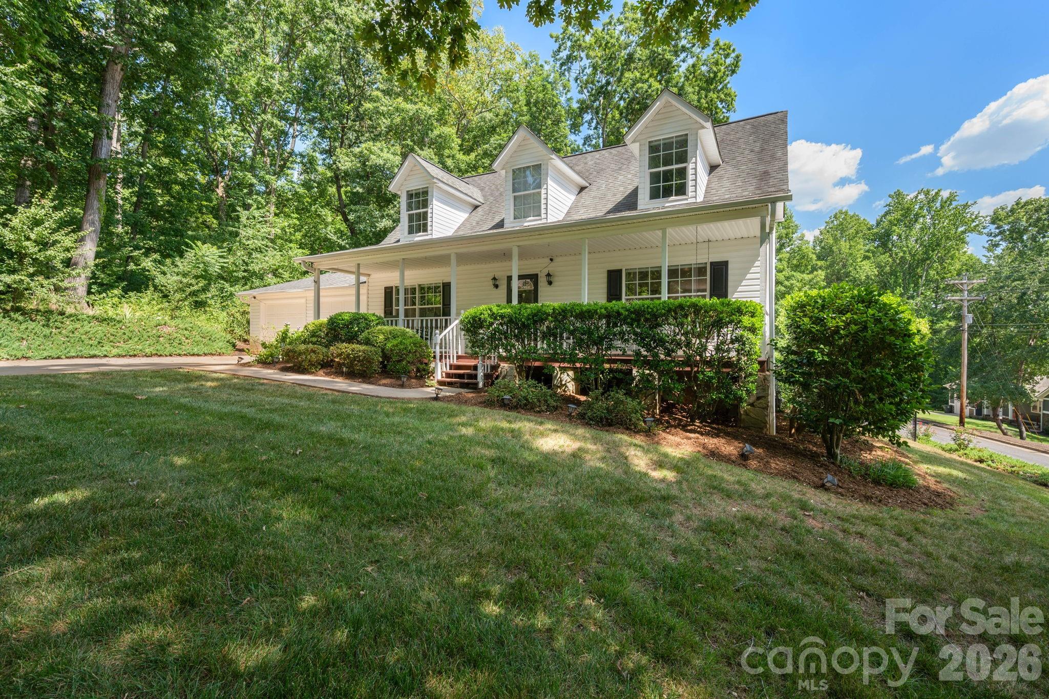 Privacy, style, and exceptional outdoor living await! Nestled on a corner lot at the end of a quiet dead-end street, this beautifully maintained home offers the peaceful setting you've been searching for. Step inside to elegant hardwood flooring that flows throughout both levels, creating warmth and timeless appeal. The inviting Great Room opens seamlessly to a stunning updated kitchen featuring white cabinetry, stainless steel appliances, granite countertops, and an oversized island with seating for five—perfect for gathering with family and friends. The main level also offers a spacious second den, a formal dining room, a convenient laundry room, and a half bath. Step outside to your own private retreat. The covered outdoor living area is designed for year-round enjoyment with beautiful wrought iron railings, decks on both sides of the home, and a large hot tub—the perfect place to relax after a long day.  Upstairs, you'll find three bedrooms, all with hardwood flooring. The spacious primary suite features a walk-in closet and a beautifully updated en-suite bath with a tiled shower and dual vanities.  Additional features include an irrigation system that keeps your yard looking its best, attached double garage, security system, gas heat, and a gas water heater. This home offers the perfect blend of privacy, comfort, and thoughtful updates—all in a desirable location.  Do not be fooled by the age of this home as there have been many updates including a fully encapsulated crawlspace, updated wiring in most of the house, plumbing updated to PEX, HVAC less than 5 years old, updated lighting and so much more! Don't miss your opportunity to make it yours!