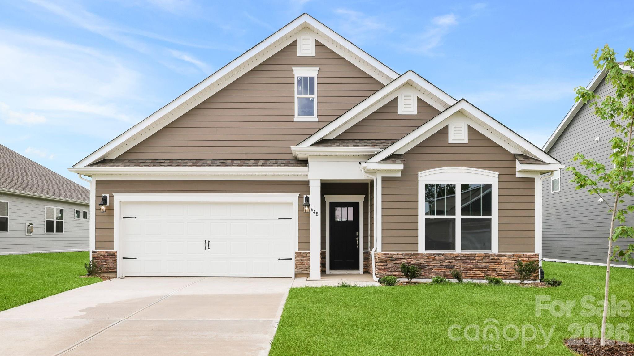 Tap Root Farms is a master planned community in Fletcher, NC featuring well-appointed single level and 2-story homes. Community features will include a 5,000 square foot resort style clubhouse with gym, large pool, playground, pickle ball courts and dog park. A best seller, this floorplan offers one level living! The owner’s suite is just off the living room with attached bathroom and walk-in closet. The kitchen has beautiful countertops, ss appliances, tile backsplash and a generous pantry. 2 additional bedrooms are located on the main floor along with additional bathroom and flex space. *Home features are subject to change without notice. Internet service not included. Sq footages are approximate*