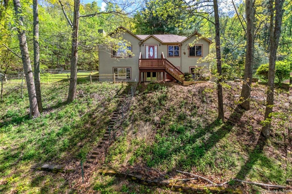Price reduced!!! Beaverdam home on large private lot. Located in the the popular Spooks Branch area, this home includes a two-car garage and walk-out finished basement. The spacious living room has a gas fireplace and huge picture windows highlighting year-round mountain views. Updated kitchen, formal dining room, and back deck. Basement great room ideal for multi-use and features a gorgeous stone FP. Large level front lawn ideal for pets and play. City water and sewer.