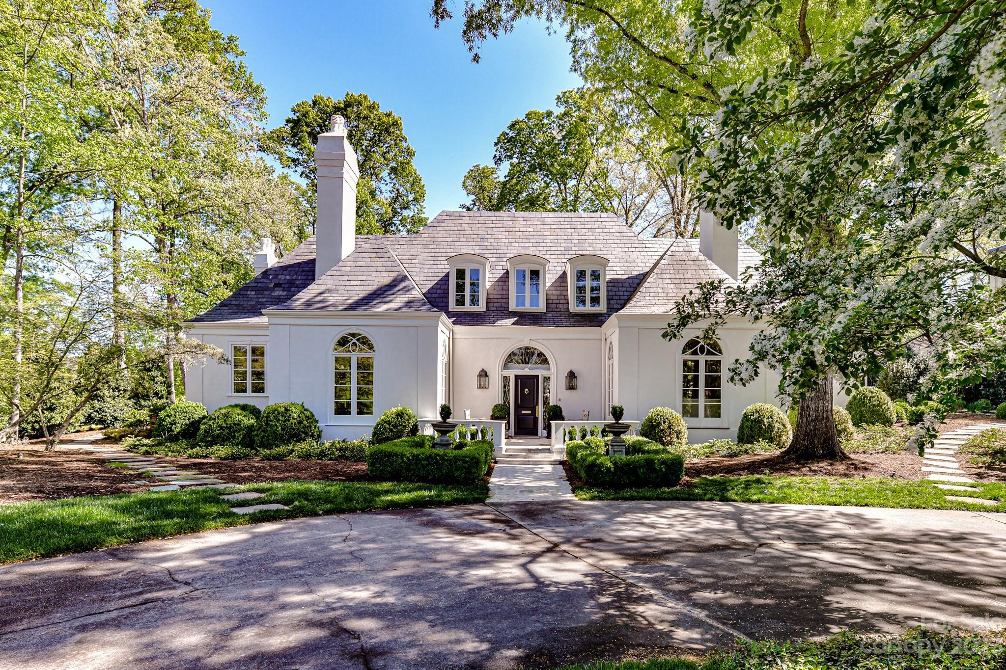 A masterpiece by renowned architect Sherman Pardue, this home exudes timeless appeal through symmetry and classic design elements drawing you into this elegant lifestyle. This 1.4-acre estate in Eastover was built for the iconic Charlotte developer John Crosland, Jr.. Entertain in the formal rooms with European detail. Walk into a light filled Italian travertine foyer. The quintessential Pardue central hall /gallery connects all living areas bringing outdoors “in” with views of the beautiful, updated pool area and “garden” rooms. An open kitchen concept, ahead of its time, features a vaulted ceiling and built-in bar for serving guests. The renovated primary bed/bath is a personal oasis. Feel the privacy afforded by the front and rear entry...YET space for entertaining in the newly landscaped grounds designed by John Howard. Full apartment above the garage. Too many details to list here. Unique property. Showings Begin Monday 4/17/2023