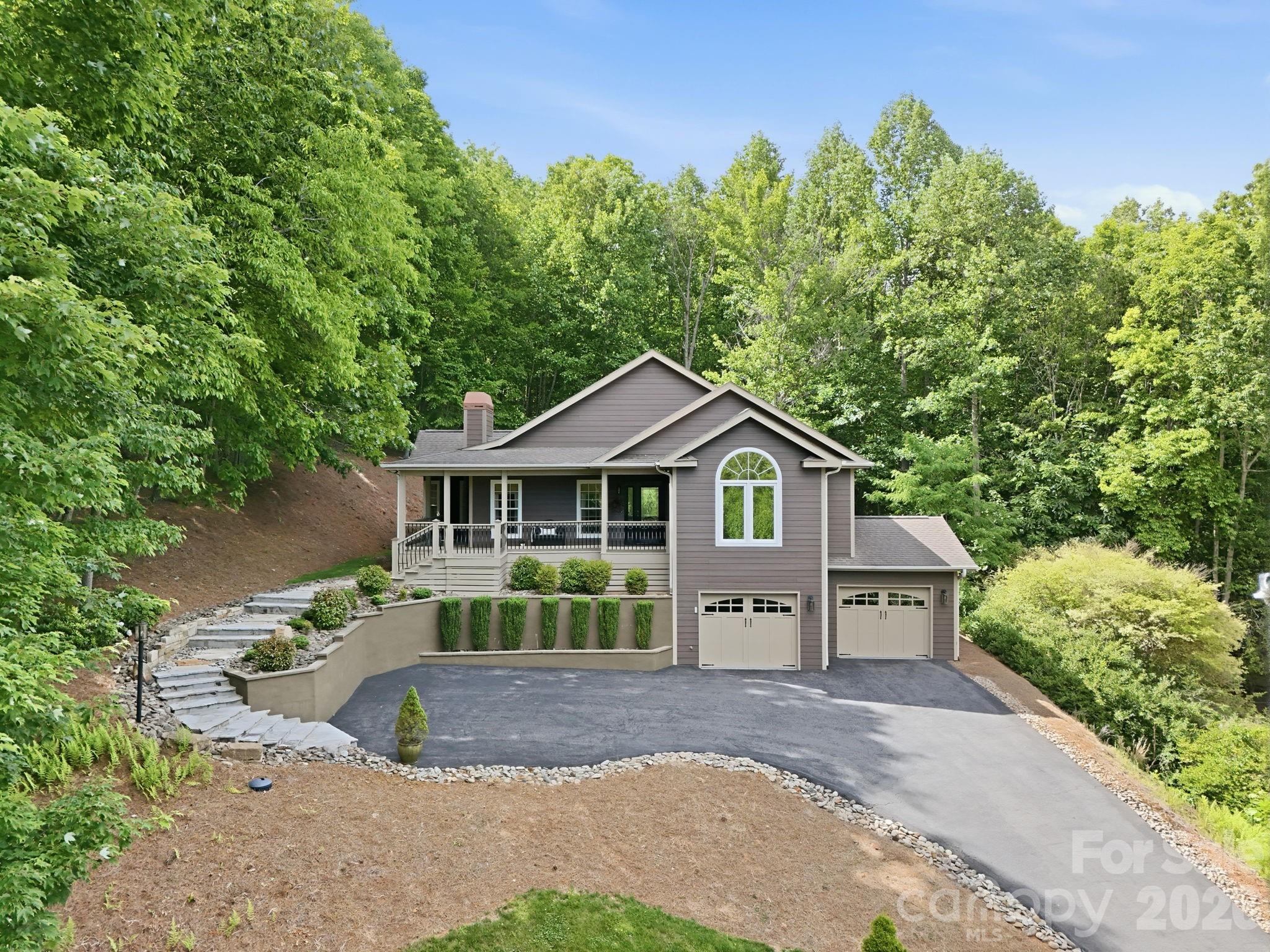 This hilltop beauty has wonderful mountain and trout pond views!  It’s located within the peaceful, gated Avery Park neighborhood adjacent to the Pisgah National Forest.  This home backs right up to the forest itself.  Walk the trails to the Blue Ridge Parkway, if you like.  The home is immaculately maintained and move-in ready.  The main level houses most of the daily used rooms, while the lower/basement level has a 2-car garage, bonus room and 4th bedroom with its en suite bath all at ground level. A delightful bonus is the screened porch out back, with loads of privacy for your relaxing pleasure.  Avery Park has a great amenity package with a trout pond, pool, pickleball/tennis court, basketball court, playground, pavilion with picnic tables with a gas grill and a clubhouse.  So close to town, yet feels far removed; a great combo!