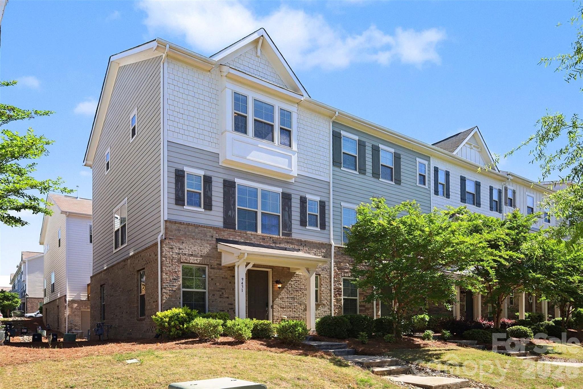 Welcome to this beautifully designed end-unit townhome in the sought-after Hadley at Arrowood Station community, where modern style meets everyday convenience. Positioned to offer added privacy and an abundance of natural light, this home stands out with its charming exterior, welcoming front porch, and thoughtfully designed three-level layout.

Inside, you’re greeted by a bright and inviting entry that leads into a versatile main-level space ideal for a home office, gym, or cozy retreat. The second level opens up into an expansive living area filled with natural light, seamlessly connecting to the dining space and a stunning kitchen designed for both everyday living and entertaining. The oversized island anchors the space, while the open layout creates an effortless flow for gatherings. Just off the main living area, a private balcony offers the perfect place to relax and unwind.

Upstairs, the home continues to impress with a spacious primary suite featuring a light-filled bedroom and a well-appointed en-suite bath, along with an additional bedroom and full bath that provide flexibility for guests or additional living needs. The overall layout is both functional and inviting, offering comfortable spaces across all three levels.

Residents of Hadley at Arrowood Station enjoy access to a beautifully maintained community with a resort-style pool, gathering spaces, and walkable streets that create a welcoming neighborhood atmosphere. The location is truly exceptional, just minutes from the LYNX Blue Line for easy commuting into Uptown Charlotte and South End, along with convenient access to shopping, dining, and everyday essentials. Outdoor enthusiasts will also appreciate the close proximity to Little Sugar Creek Greenway, offering miles of scenic trails for walking, running, and biking.