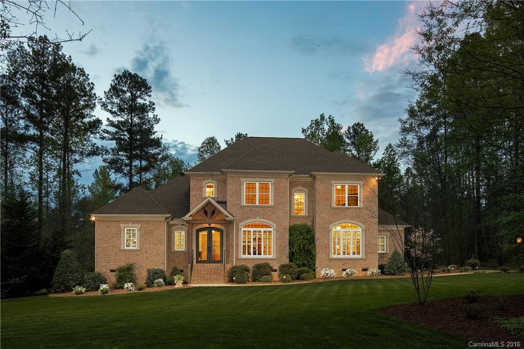 Custom built executive home w/seasonal lake views on 1.4 acres. 10'ceilings/ 8'doors through first floor,
kitchen w/custom cabinets, granite counters & Thermador appliances. Wood burning fireplace in 2 story great room w coffered ceiling. Rounded corners on sheet rock, detailed moulding! Master-on-main; double trey ceiling, closet w/built-ins, master suite w/jetted tub, double sinks/marble counters. All bedrooms-WIC. Screened porch & deck - Trex, walk-in-attic/tons of storage. 3.5 car garage.