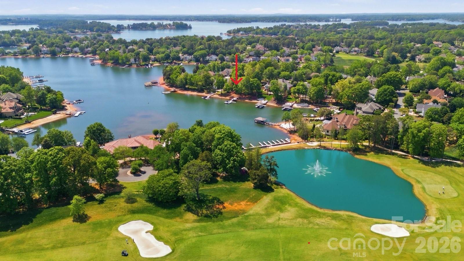 Waterfront home with a private dock on one of the most prestigious and quietest streets in the Peninsula. Immaculately maintained, this home awaits your personal touches. A European Contemporary with an open floor plan that leads to a terrace with water views and outdoor kitchen and dining. An amazing property but needs a little vision to make it your own lakefront slice of heaven. Preliminary pool approval from the HOA and room for expansion on the lower level. 3 car garage with hydraulic lift. A very short distance to the Peninsula Club (separate membership required) featuring golf, tennis, pickleball, swimming and fine dining. All amenities are a short distance away and downtown CLT and the airport just 35 minute drive away.