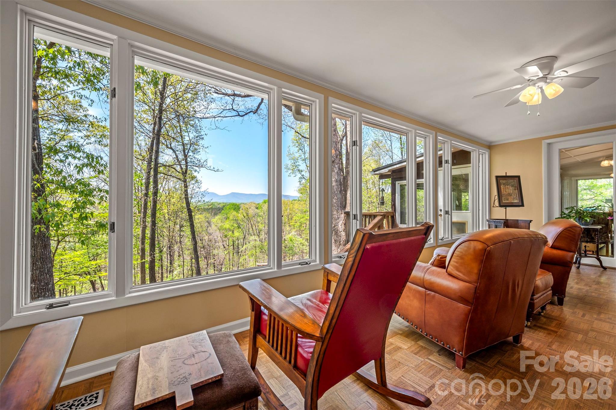 Discover your private sanctuary in the heart of sought-after Tryon Hunting Country, where nature and tranquility take center stage. Tucked away at the end of a picturesque, canopied drive, this serene, recently updated property offers a rare opportunity to embrace peaceful living with direct access to the renowned FETA trail system, which meanders through the land, along with carefully maintained private hiking trails. Surrounded by natural beauty, the home is thoughtfully designed to bring the outdoors in. Expansive windows throughout create a treehouse-like atmosphere, showcasing stunning year-round mountain views from nearly every room and filling the space with natural light. The open-concept layout and split-bedroom floor plan offer both comfort and functionality—ideal for entertaining guests or enjoying quiet evenings by the double-sided fireplace, shared between the living room and sunroom. There are two bedroom suites, plus a guest bedroom/office. The well-appointed kitchen (with new Wolf and Bosch appliances) serves as the heart of the home, while a versatile multipurpose room with a built-in window seat and storage adds flexibility for work, relaxation, or hobbies. Every detail is designed to enhance the connection to nature while providing modern comfort. The property offers horse amenities, with a new run-in shelter with a feed/tack room, and new fencing. The detached garage/workshop presents excellent potential for conversion into a studio or additional living quarters. A septic permit for the conversion is on file. An additional adjacent 5-acre parcel is available for purchase to expand grazing. Whether you’re seeking a peaceful retreat, an outdoor enthusiast’s haven, or the foundation for your dream equestrian lifestyle, this unique property offers endless possibilities in an unmatched natural setting.