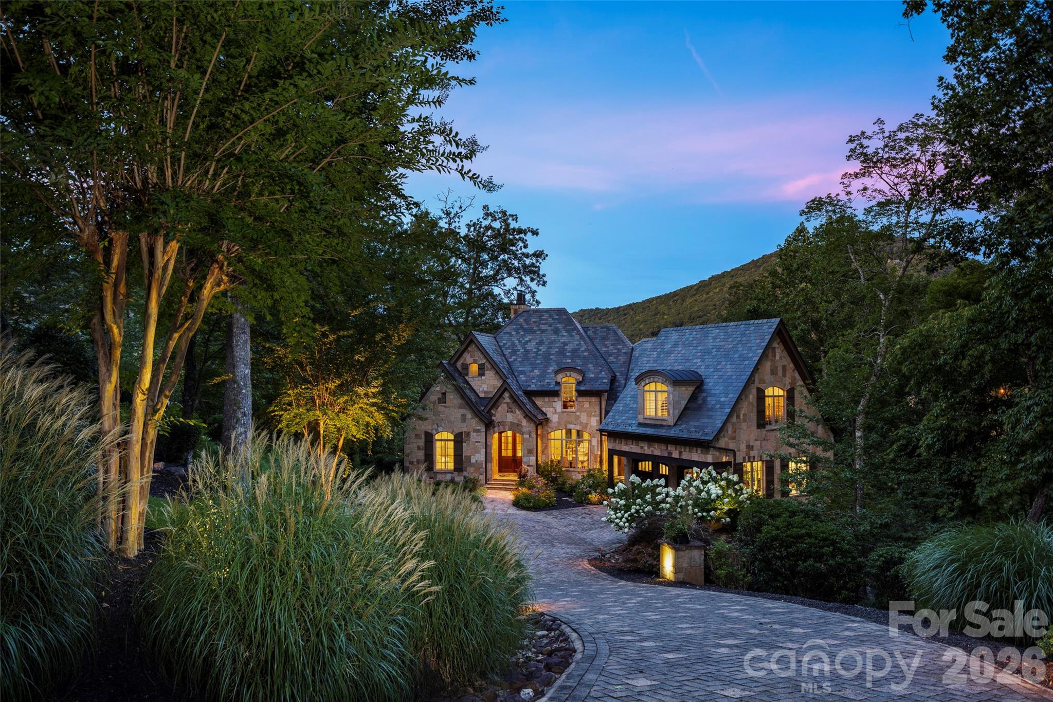 Refined and timeless, this distinguished stone estate at 1829 Bella Vista Court represents the pinnacle of luxury living within The Cliffs at Walnut Cove. Nestled on private acreage in one of the community’s most tranquil golf course settings, the residence is enveloped by the natural splendor of the Blue Ridge Mountains. The meticulously maintained interior offers an ambiance akin to new construction, characterized by a sophisticated neutral palette and soaring ceilings that invite an abundance of natural light. The main level’s open-concept design—comprising a gourmet kitchen, formal dining room, and an elegant breakfast area—serves as the heart of the home, ideal for hosting formal engagements or intimate gatherings.

Residents of this exclusive enclave enjoy access to a world-class suite of amenities that define the premier mountain lifestyle. The community is home to a championship Jack Nicklaus Signature golf course, a sprawling 18,000-square-foot wellness center featuring indoor and outdoor pools, and over six miles of private nature trails. Beyond the gates, membership offers reciprocal privileges across all seven Cliffs communities, including additional nationally-acclaimed courses and equestrian facilities. Strategically positioned just minutes from the vibrant culture of downtown Asheville and the Asheville Regional Airport, this estate—complete with an additional lot to preserve its idyllic privacy—offers an unparalleled marriage of modern comfort and Old World elegance.