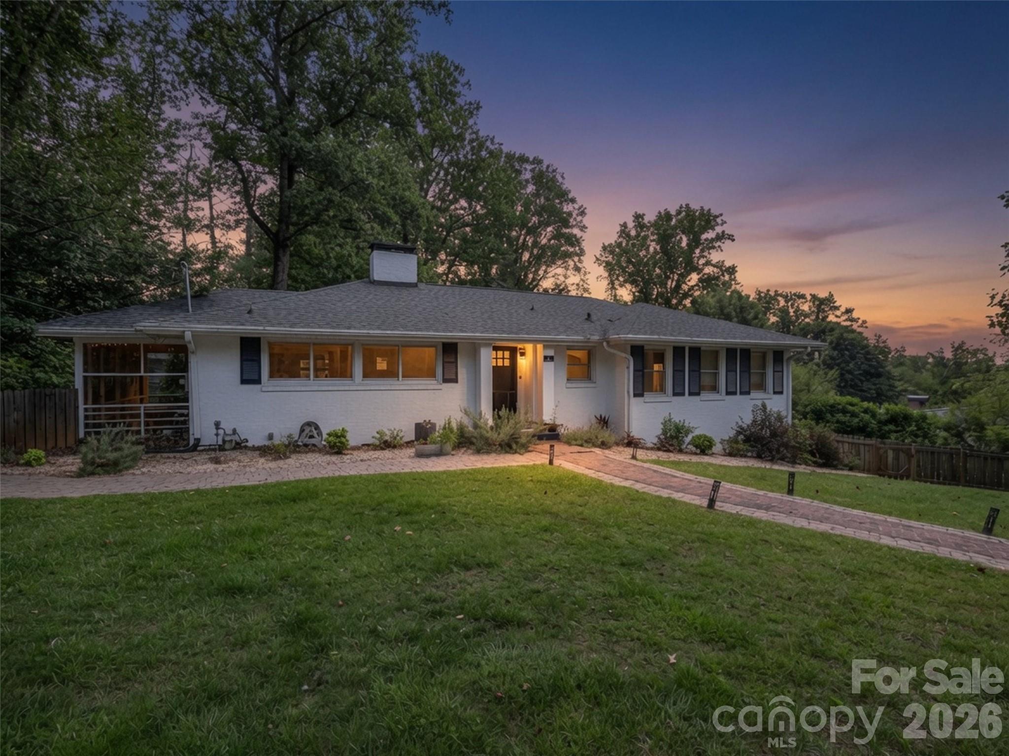 Beautifully reimagined and move-in ready, this renovated Oak Forest ranch blends timeless character with sophisticated modern updates. Set on a private, level lot with mature landscaping, the home offers flexible living spaces designed for today's lifestyle. The heart of the home is the stunning chef's kitchen featuring premium appliances, custom finishes, and an inviting fireside gathering space. Hardwood floors, designer lighting, solid oak doors, and thoughtfully renovated baths create a polished, upscale feel throughout. The spacious lower level with separate entrance, living area, bedroom, and full bath offers exceptional versatility for guests, multigenerational living, a home office, or creative pursuits. Outdoor living shines with a screened porch, deck, pergola lounge, new greenhouse, fenced patio, and abundant room to relax or entertain. Tucked into one of South Asheville's most established and desirable neighborhoods, just minutes from shopping, dining, schools, and everyday conveniences, this is the rare home that feels as good as it looks! Also available for lease.