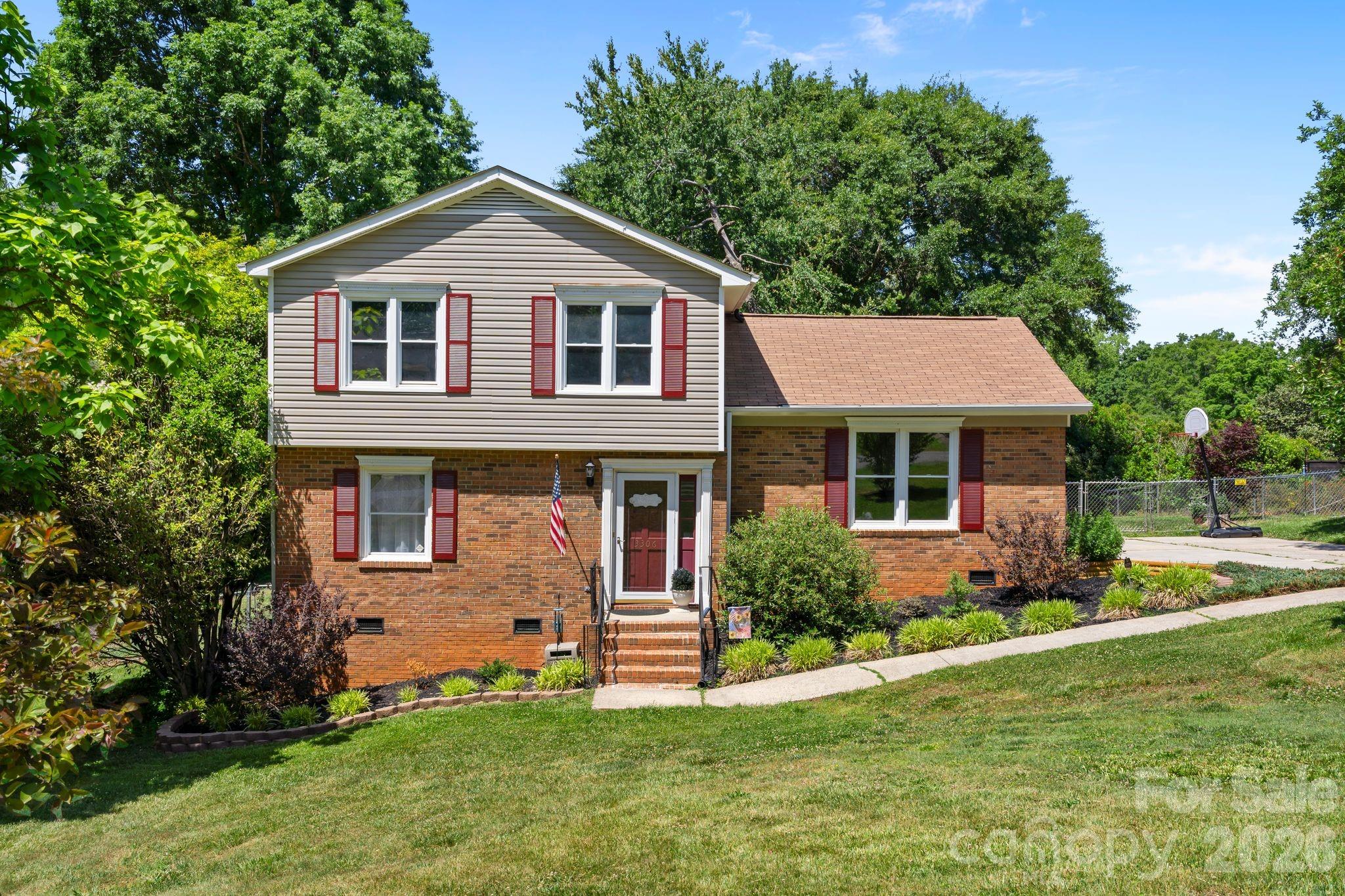 Welcome to this charming split-level home located in the desirable Suburban Heights neighborhood of Gastonia. Situated on a spacious 0.41-acre lot, this well-maintained property offers a perfect blend of comfort and functionality. With a total of 3 bedrooms and 3 bathrooms, this home is ideal for family living. The upper level features a spacious primary bedroom with an en-suite bathroom, as well as two additional bedrooms that share a full bath. The lower level includes a cozy great room with a wood-burning fireplace, an additional full bath, an office space and a large flex-space. The flex-space can easily be used as an additional bedroom, offering versatility for various living needs. The kitchen is a highlight of the home, featuring a convenient movable island and a pantry for extra storage. Enjoy the outdoors with a private deck, perfect for entertaining or unwinding in your own space. The property also includes a fenced backyard, complete with fruit trees, and plenty of space for gardening or outdoor activities. This home is equipped with modern amenities, including a heat pump, central air, and ENERGY STAR-qualified appliances, ensuring comfort year-round. The property has a concrete driveway with room for 3-4 cars, along with additional on-street parking. Located in a peaceful neighborhood, yet close to major amenities, Crowders Mountain, Gastonia Park and I-85, this home offers the best of both worlds. Don’t miss the opportunity to make this wonderful property yours! Schedule your showing today. $5000 seller credit towards new kitchen countertops and flooring!