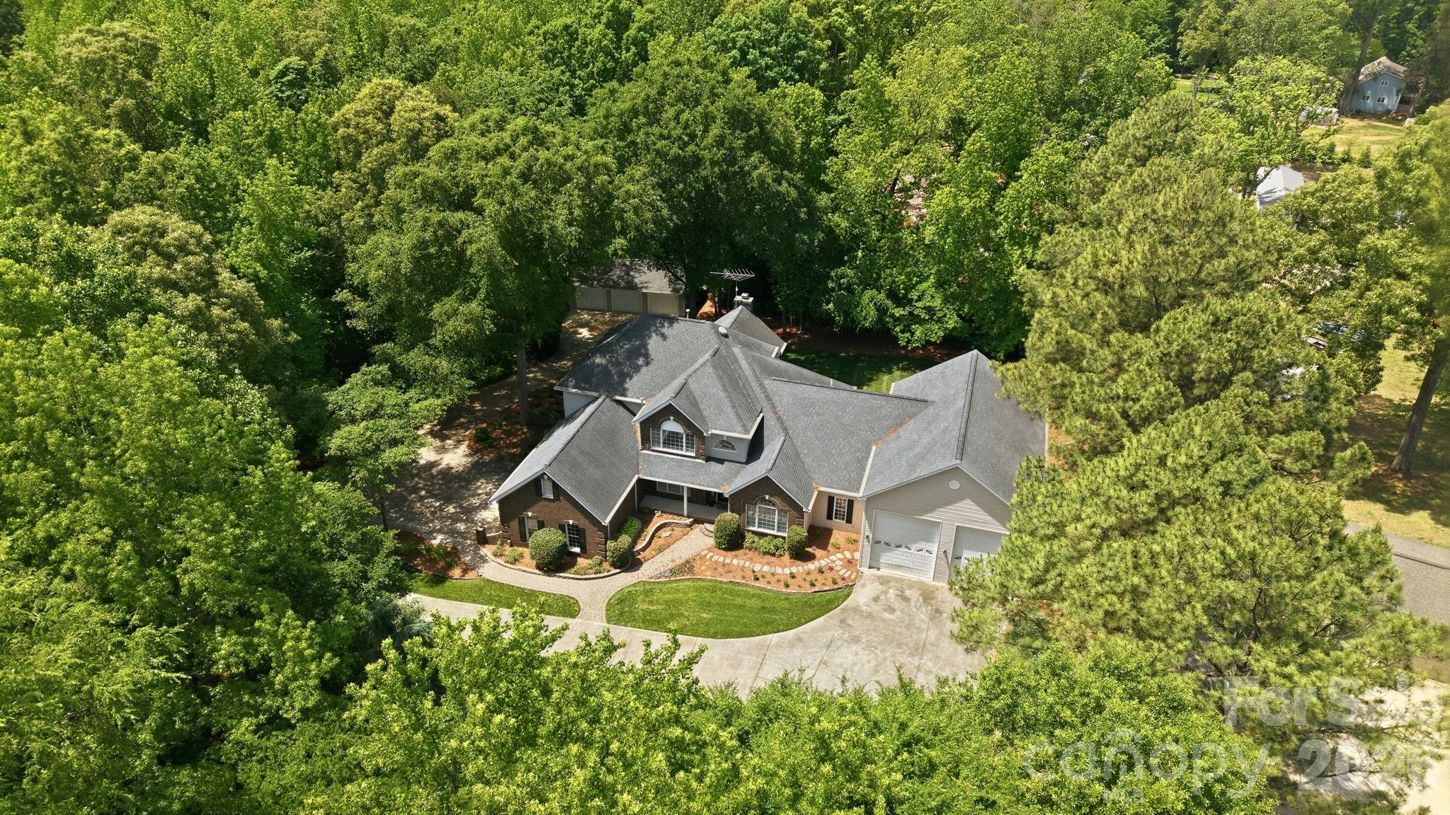 Custom-built luxury meets exceptional functionality in this impressive 5-bedroom, 5.5-bath home on almost 2 private acres in Fort Mill, SC.   Designed for elevated everyday living and effortless entertaining, this move-in ready home offers a rare combination of space, flexibility, and craftsmanship with every bedroom featuring its own private bath.  Enjoy a large chef equiped kitchen with luxury appliances. The thoughtfully designed layout includes both a primary suite on the main level and a private guest bedroom on main, ideal for multigenerational living, executive relocation buyers, long-term guests, or a private home office setup.
The expansive garage space with 8 bays, over 1,900 square feet in total including 2 RV height bays is a standout feature for car enthusiasts, hobbyists, storage needs, or workshop potential. Spacious living areas, custom details, and a flowing floor plan create the perfect balance of comfort and sophistication. Situated on a generous homesite with convenient access to Fort Mill, Ballantyne, Charlotte, I-77, and Charlotte Douglas International Airport, this location also offers easy access to Uptown Charlotte, Carowinds, Anne Springs Close Greenway, and premier shopping, dining, and entertainment destinations throughout the Charlotte metro region. Rare opportunities like this custom Fort Mill home with dual bedrooms on main and private baths throughout do not come along often.