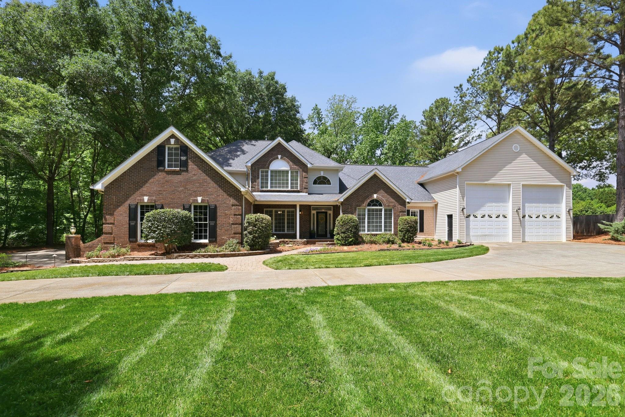 Custom-built luxury meets exceptional functionality in this impressive 5-bedroom, 5.5-bath home on almost 2 private acres in Fort Mill, SC.   Designed for elevated everyday living and effortless entertaining, this move-in ready home offers a rare combination of space, flexibility, and craftsmanship with every bedroom featuring its own private bath.  Enjoy a large chef equiped kitchen with luxury appliances. The thoughtfully designed layout includes both a primary suite on the main level and a private guest bedroom on main, ideal for multigenerational living, executive relocation buyers, long-term guests, or a private home office setup.
The expansive garage space with 8 bays, over 1,900 square feet in total including 2 RV height bays is a standout feature for car enthusiasts, hobbyists, storage needs, or workshop potential. Spacious living areas, custom details, and a flowing floor plan create the perfect balance of comfort and sophistication. Situated on a generous homesite with convenient access to Fort Mill, Ballantyne, Charlotte, I-77, and Charlotte Douglas International Airport, this location also offers easy access to Uptown Charlotte, Carowinds, Anne Springs Close Greenway, and premier shopping, dining, and entertainment destinations throughout the Charlotte metro region. Rare opportunities like this custom Fort Mill home with dual bedrooms on main and private baths throughout do not come along often.