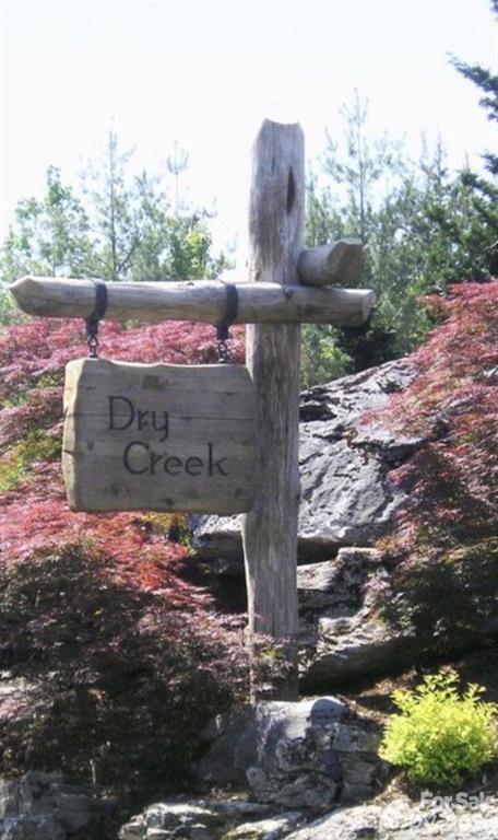 The beautiful Dry Creek community has larger, wooded homesites and allow homes with a rustic feel.  Dry Creek residents share the amenities of Southpointe including a pool, clubhouse, and community boat slips.  The Fonta Flora Trail system crosses through the SouthPointe community allowing for wonderful outdoor recreation trails.  Lot 29 is a private 1.62+/- acre lot with a flat building area and access to Lake James through your back yard and the community owned, conservation area.  You can launch your paddle board, canoe or kayak from the conservation area right out of your backyard.  In addition you have your full size deeded boat slip #52 to store your private boat as you enjoy the recreational gem of Lake James.  You are close to Lake James State Park, the Linville Gorge Wilderness all while being only 12 miles from downtown Morganton.