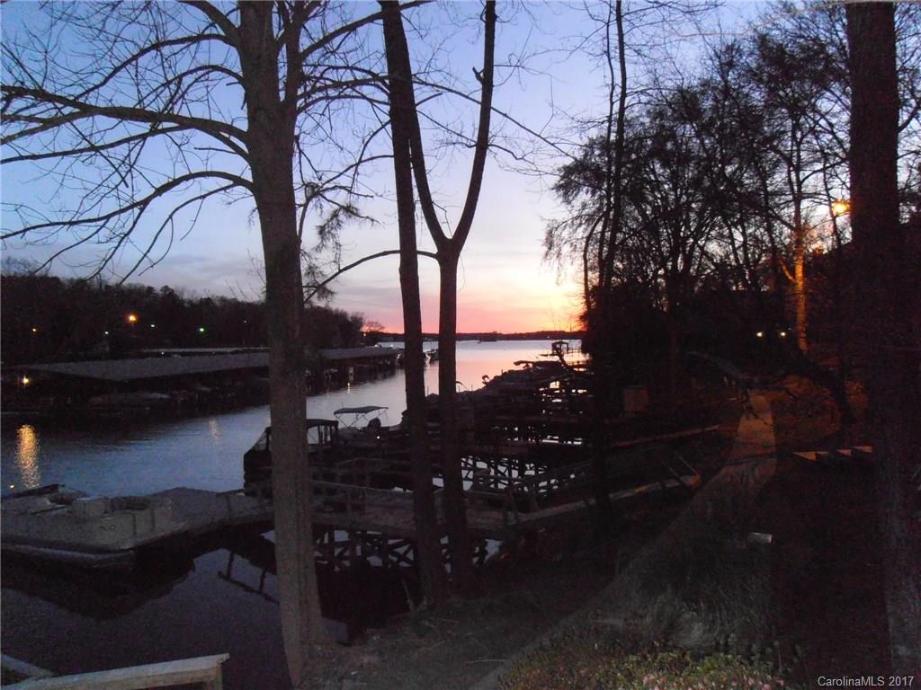 Waterfront end unit townhome with shared dock, fabulous view and location, 2 bdrm each w/private bth, great room w/fireplace, eat in kit, formal dining room, wood floors through the main living area, tile in kitchen. Relax on the deck overlooking the lake and marina. There are planters for gardening, lower deck and a walk-in crawl area, awesome location! Enjoy everything Tega Cay has to offer!  Bring your boat and toys!! Offered As-Is