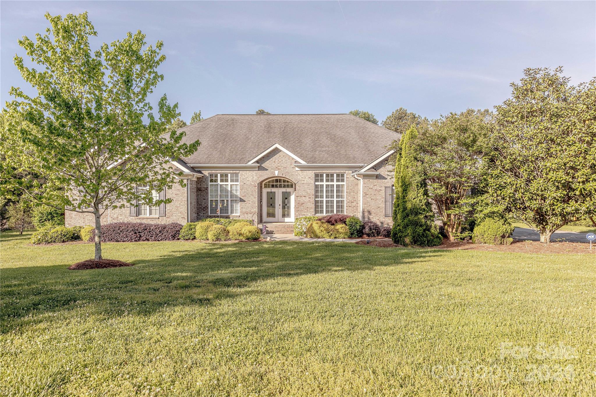 Located within a short distance to Ballantyne in the desirable neighborhood of Millstone Creek this beautifully landscaped custom all-brick ranch home has one of the best lots in the neighborhood. Situated on a flat 1 acre backyard that is fully fenced and backing up to wooded privacy. This open floor plan has 11ft ceilings and hardwood floors featuring an expansive living room and gas fireplace, Kitchen with an eat-in breakfast nook, formal dining room, office with french doors, and a 3 car garage. With a split bedroom plan, The primary bedroom has a bay window sitting area with access to the screened porch, an additional guest suite with en-suite bathroom, and 2 additional spacious bedrooms each with a walk-in closet. Enjoy the outdoors from your screened-in porch and large deck perfect for entertaining.