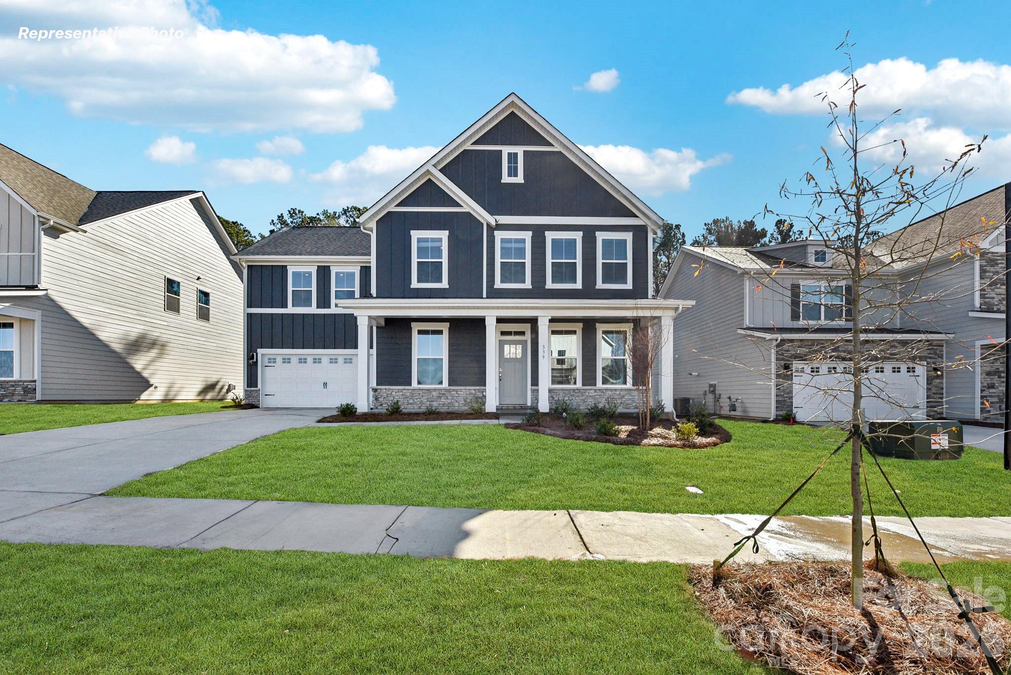 Come see 7046 Wishing Well Way located in York, South Carolina!

The Greenwood is one of our two-story plans at Westport in York, SC. This home features four bedrooms, including a bedroom on the main floor,  three bathrooms, loft and a two-car garage, making it perfect for your new home.

Upon entering the home, you'll be greeted by an inviting foyer that leads you past a bedroom on the main level with en-suite bathroom. A flex space is also in this area and would make a great home office. This opens into an impressive space featuring a living room, dining area, and well-appointed kitchen. The kitchen is equipped with a pantry, stainless steel appliances, and a large island with a breakfast bar, making it perfect for both cooking and entertaining.

Upstairs this home also features a primary suite, complete with a large walk-in closet and en suite bathroom featuring dual vanities and a separate tub and shower. The additional two bedrooms share a full bath that includes dual vanities. A spacious loft and laundry room complete the second level.

With its thoughtful design, spacious layout, and modern conveniences, the Greenwood is waiting for you at Westport in York, SC.

Pictures are representative.