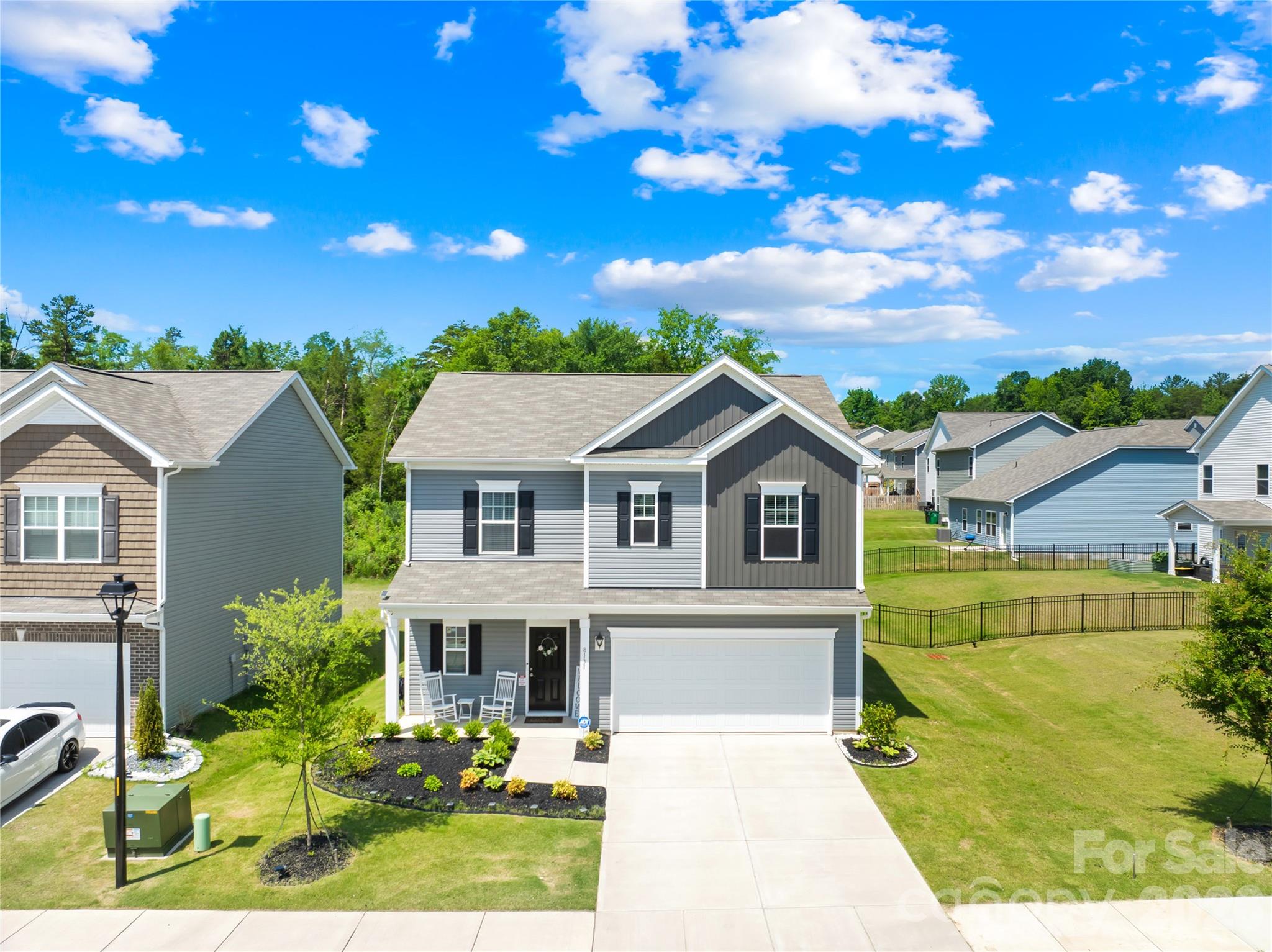 Welcome to 8131 Jonagold Lane. Built in 2024 with only a single occupant, this home is truly move-in ready. Offering 3 bedrooms, 2.5 bathrooms, and modern touches. With luxury vinyl plank flooring throughout the home, thoughtful upgrades, and a functional layout, this home delivers the benefits of new construction without the wait. This community backs up to Reidy Creek Nature Preserve which has trails, dog park, disc golf course, hiking, and countless outdoor activities. The open-concept main level is designed for everyday living and entertaining, featuring a spacious kitchen with a large center island with bar seating, abundant cabinet and countertop space, and a seamless flow into the living room. Upstairs, the spacious primary suite offers a large walk-in closet and an ensuite bathroom complete with a tub and ample storage. Two additional bedrooms, generous closet space, and a conveniently located upstairs laundry room make daily living both comfortable and efficient. Step outside to a fully fenced backyard with elegant black aluminum fencing and a spacious rear patio that's perfect for grilling, entertaining, or relaxing after a long day. A covered front porch, two-car garage, and neighborhood sidewalks add to the home's curb appeal and functionality. Ideally located with quick access to UNC Charlotte, Uptown Charlotte, major highways, shopping, dining, and nearby light rail access, this meticulously maintained home offers modern finishes, low-maintenance living, and an exceptional location you'll love coming home to.