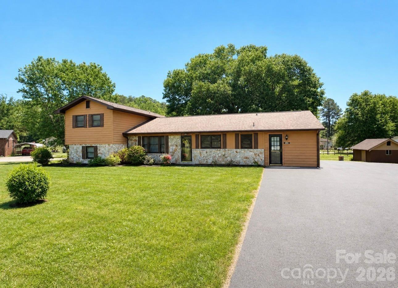 Impeccably maintained home perfectly situated in the heart of desirable Pleasant Gardens! Enjoy the convenience of being close to town and I-40, without being in city limits. This property features a spacious, level yard and 2 storage buildings to provide ample space for tools, outdoor equipment, and extra storage. The back deck is perfect for grilling and entertaining friends!  With 3 bedrooms, a 4th bonus room, living room, den w/gas logs, and workshop area, this move-in ready gem offers tons of space, as well as new & newer appliances. As an added bonus, city water hookup is available! Inside and out, this home reflects pride of ownership with its well-kept condition and thoughtful layout. Space, convenience, and a great location...this one checks all the boxes!!