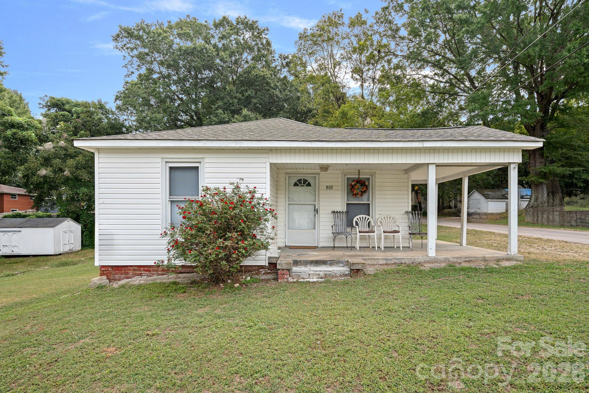 With proximity to the North Carolina Research Center and the new Kannapolis Cannon Ballers Stadium, this location is prime!  The rocking chair wrap around front porch welcomes you into this cozy, corner lot home.  The eat-in kitchen boasts beautifully detailed wood cabinets, tile countertops, and tile backsplash.  Three bedrooms or use one of the rooms as an office.  The roof was replaced in 2024 and insulation was added to the attic to ensure efficiency with heating and cooling.  Fully furnished, this home is perfect for anyone looking for an investment property, relocating or first time home buyers.