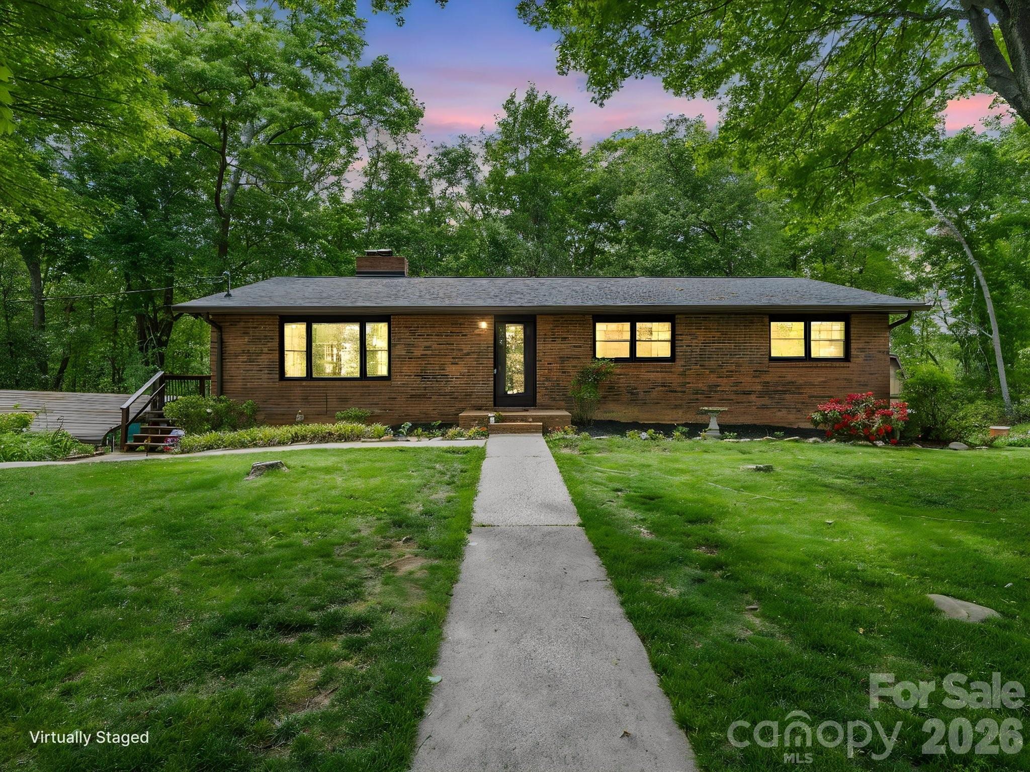 Tucked away on a beautiful, private lot of over 1 acre, this inviting home offers the perfect blend of space, flexibility, and location in one of the area’s most desirable communities. Located in the heart of Mills River, this property enjoys a peaceful setting with established landscaping, abundant wildlife, and frequent visits from deer and the area’s beloved white squirrels — all while being just minutes from everyday conveniences.

The main level features 3 bedrooms and 2 full bathrooms with comfortable living spaces and a functional layout designed for everyday living. Additionally, there are hard floors throughout, a gas fireplace, and a covered back porch overlooking the private back yard. Downstairs, the finished basement offers exceptional versatility with a spacious den featuring a cozy gas fireplace, a full second kitchen, an additional bedroom, and its own separate exterior access. Whether you’re looking for multi-generational living, guest quarters, a private home office setup, rental potential, or extra entertaining space, the basement opens the door to countless possibilities.

Outside, enjoy the mostly level yard with room for gardening, play, pets, or simply relaxing in the privacy of your own backyard retreat. Major updates include a newer septic system and a roof installed in 2024. Outside, you'll also find 2 carports and a shed. Lots of room for cars and extra storage!

Location is everything, and this home delivers. Situated in the sought-after Mills River Elementary School district, you’ll also enjoy quick access to Asheville Regional Airport in approximately 10 minutes, while remaining conveniently close to Asheville (25 mins), Hendersonville (15 mins), and Brevard (20 mins). With its combination of privacy, flexibility, and unbeatable location, this property is a rare opportunity in highly desirable Mills River.