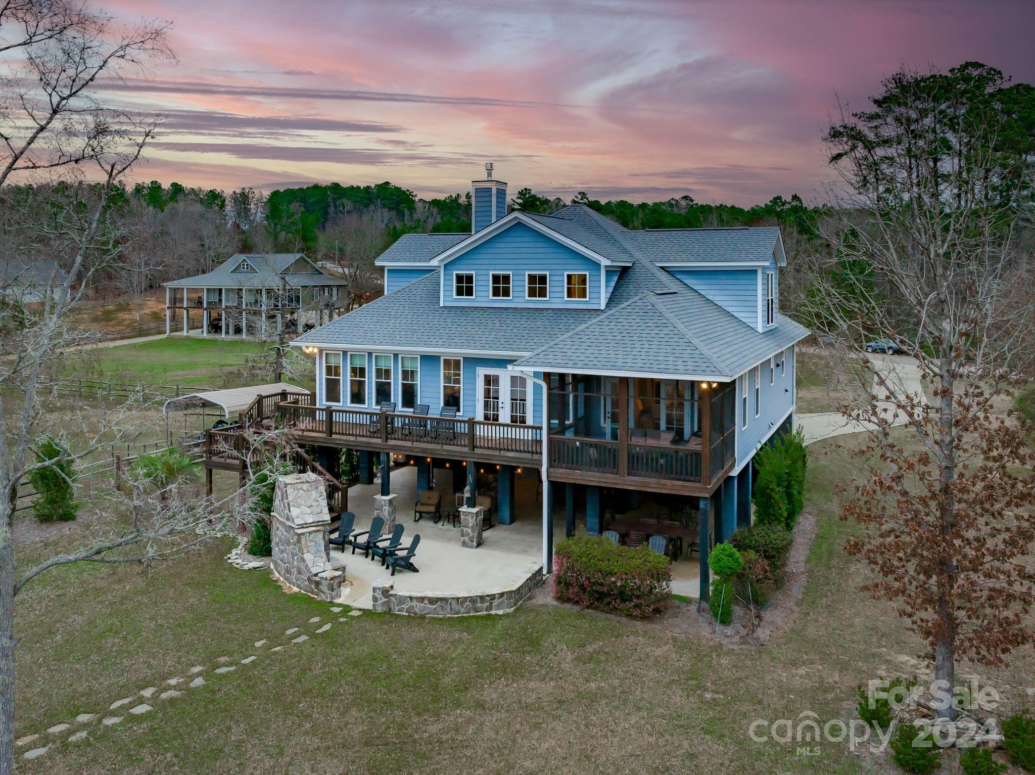 Located in the gated Retreat Lane community on the main channel with breath-taking sunset views! You'll never want to leave home! The generous lot has a paved drive, a rip rap sea wall and stationary dock with floater, boat lift and 2 jet ski ports. The home, just built in 2016, has an enormous entertainment space underneath with 2 garage bays, a huge open party area complete with bar, Tv's, multiple sitting and dining areas and a gorgeous stone fireplace. There is also a full bath and plenty of storage for lake toys on this lower level. On the main level, you'll find a fantastic great room with huge lake views that center around an oversized kitchen island, a gas fireplace and convenient laminate floors, screened porch and deck. The master bedroom, guest suite and office/5th bedroom are also on the main level. Upstairs, your guests will enjoy their own second great room, two large guest rooms and a shared bath with 3 vanities! Make it yours just in time for summer!