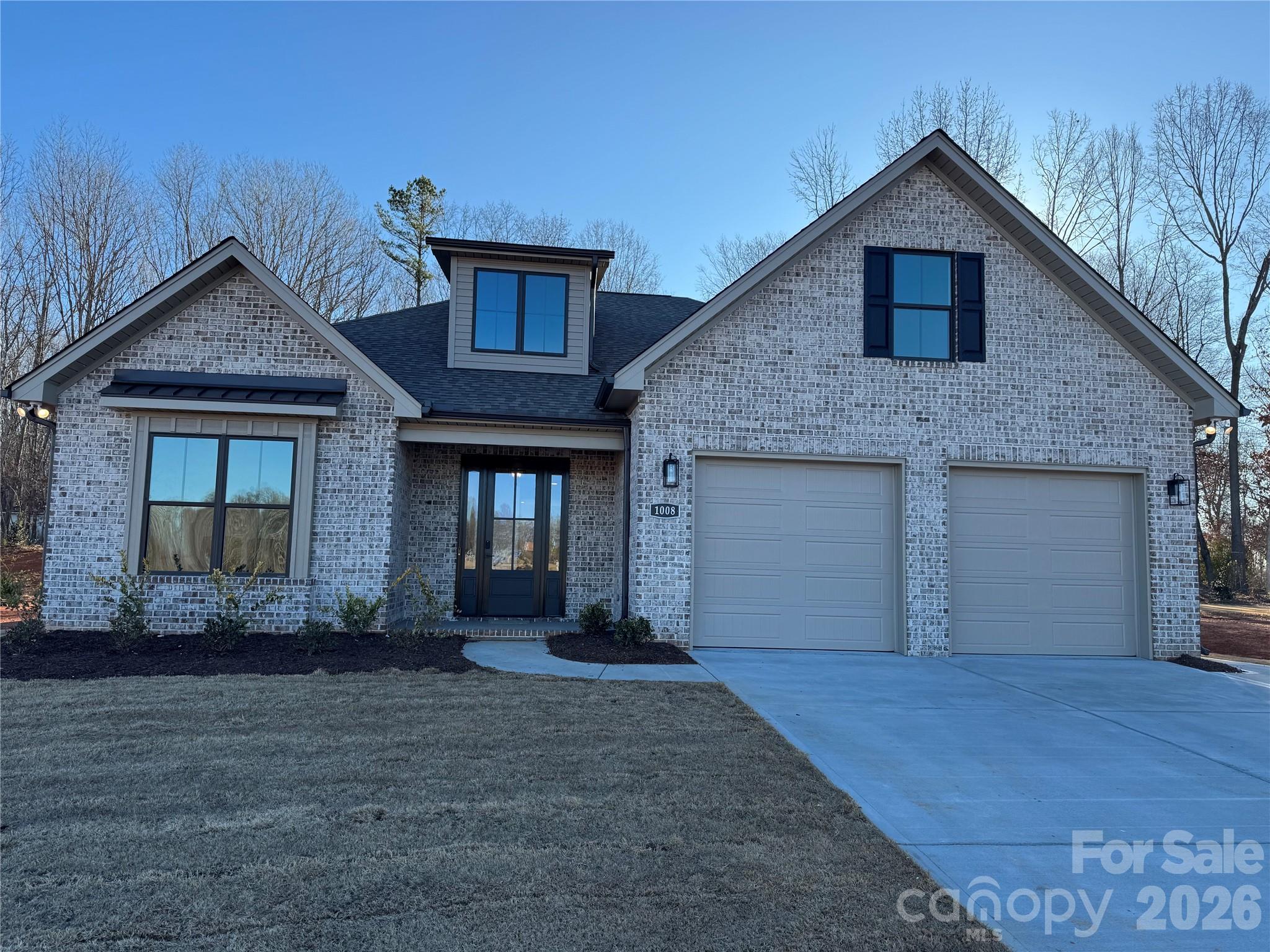 This home is like the model without the many upgrades. The  price of $625,000 is the base price and the picture is representative of the upgraded version. The garage door on the base unit has a single door and the bump out in the front bedroom is an upgrade too. We welcome you to visit our open houses next door or come take a self-guided tour at your convenience.
